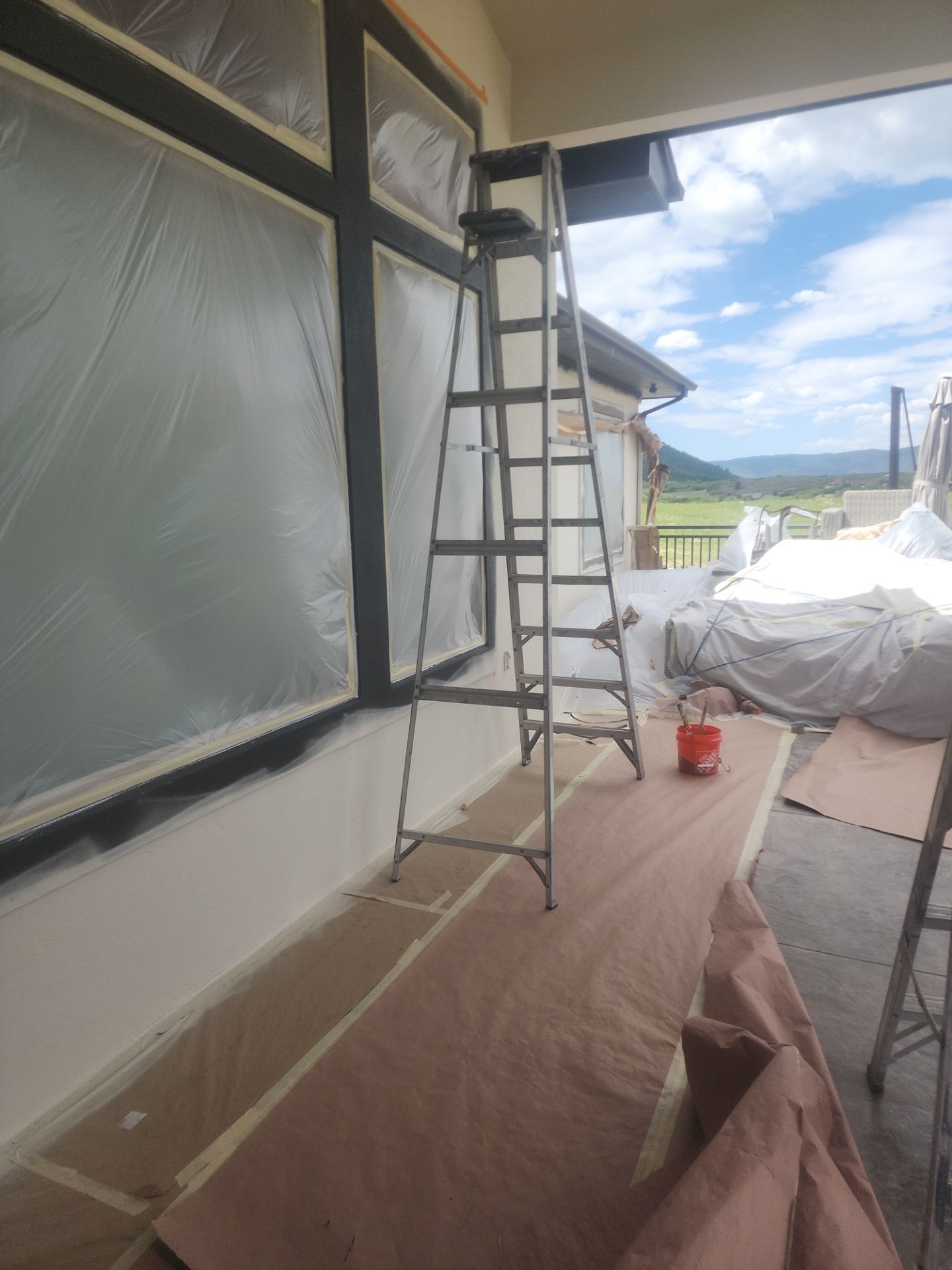 Castle Rock Elegance: White Stucco Exterior with Bold Tricorn Black by J&M Painting LLC