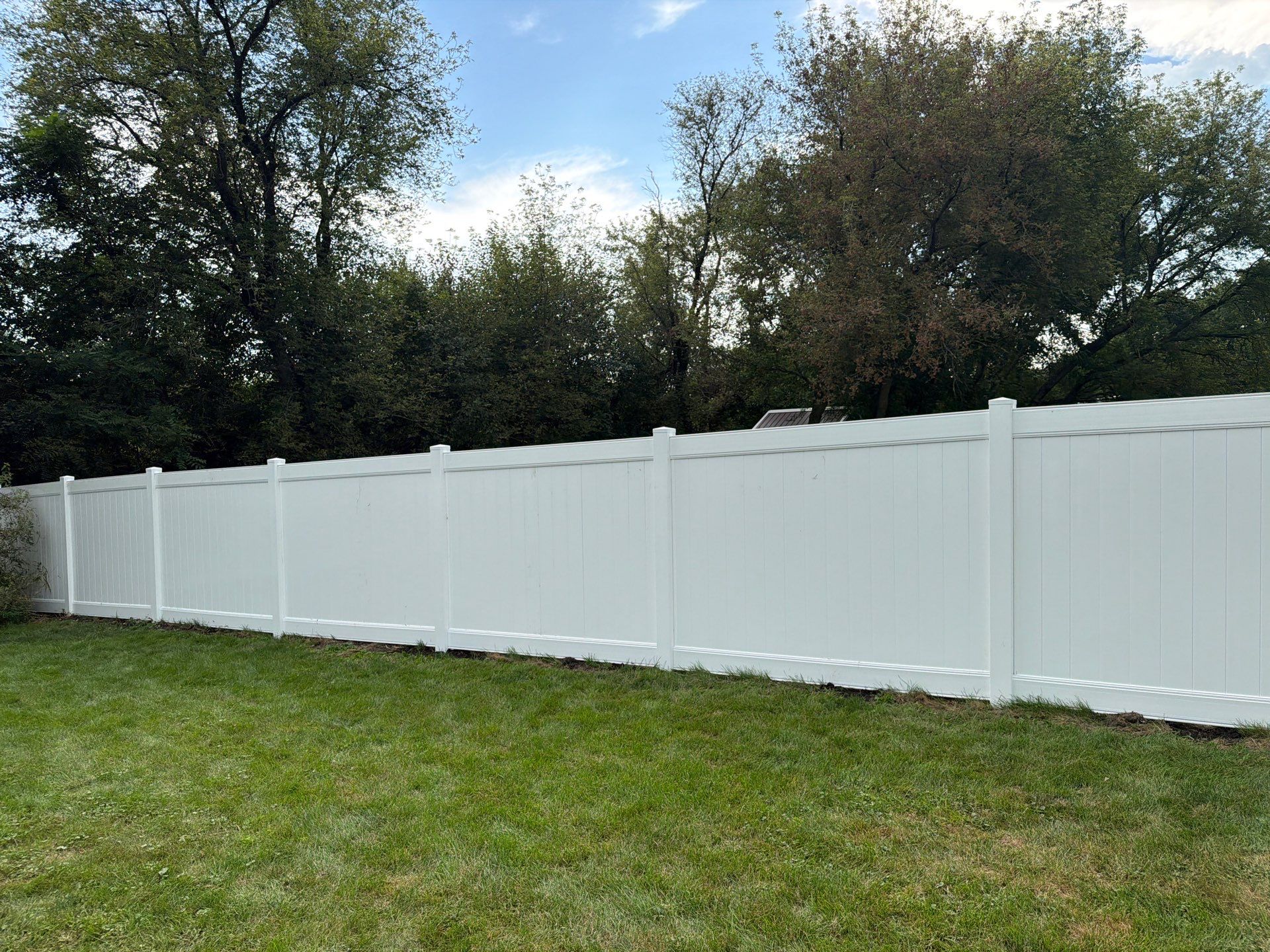 White Vinyl Privacy Fence Installation in Raymond, IA by Perfect Picket Fence and Stain