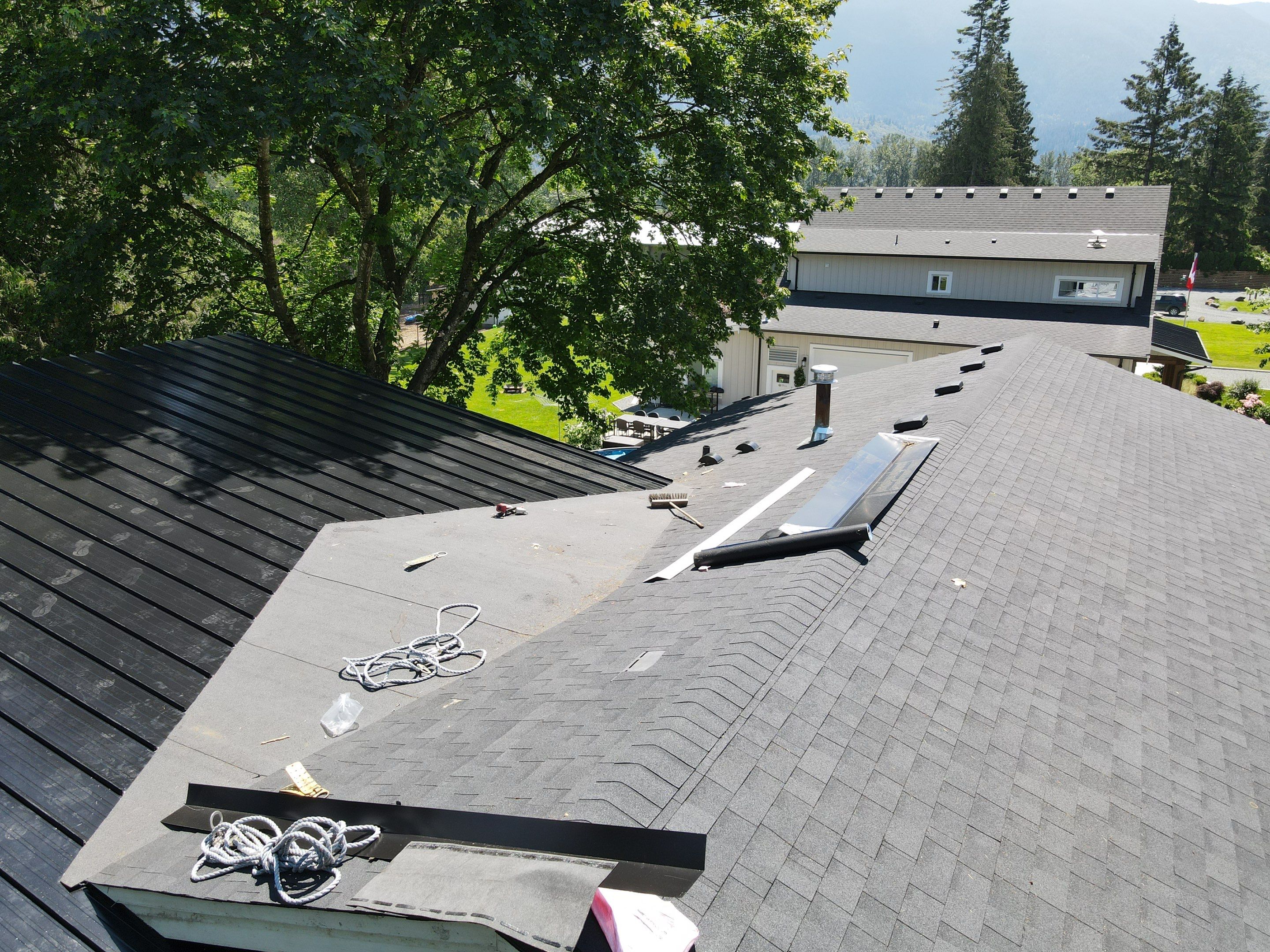 Residential Roofing Installation using 12" Prolok metal, shingles and Torch on roofing by Top Notch Roofing Inc