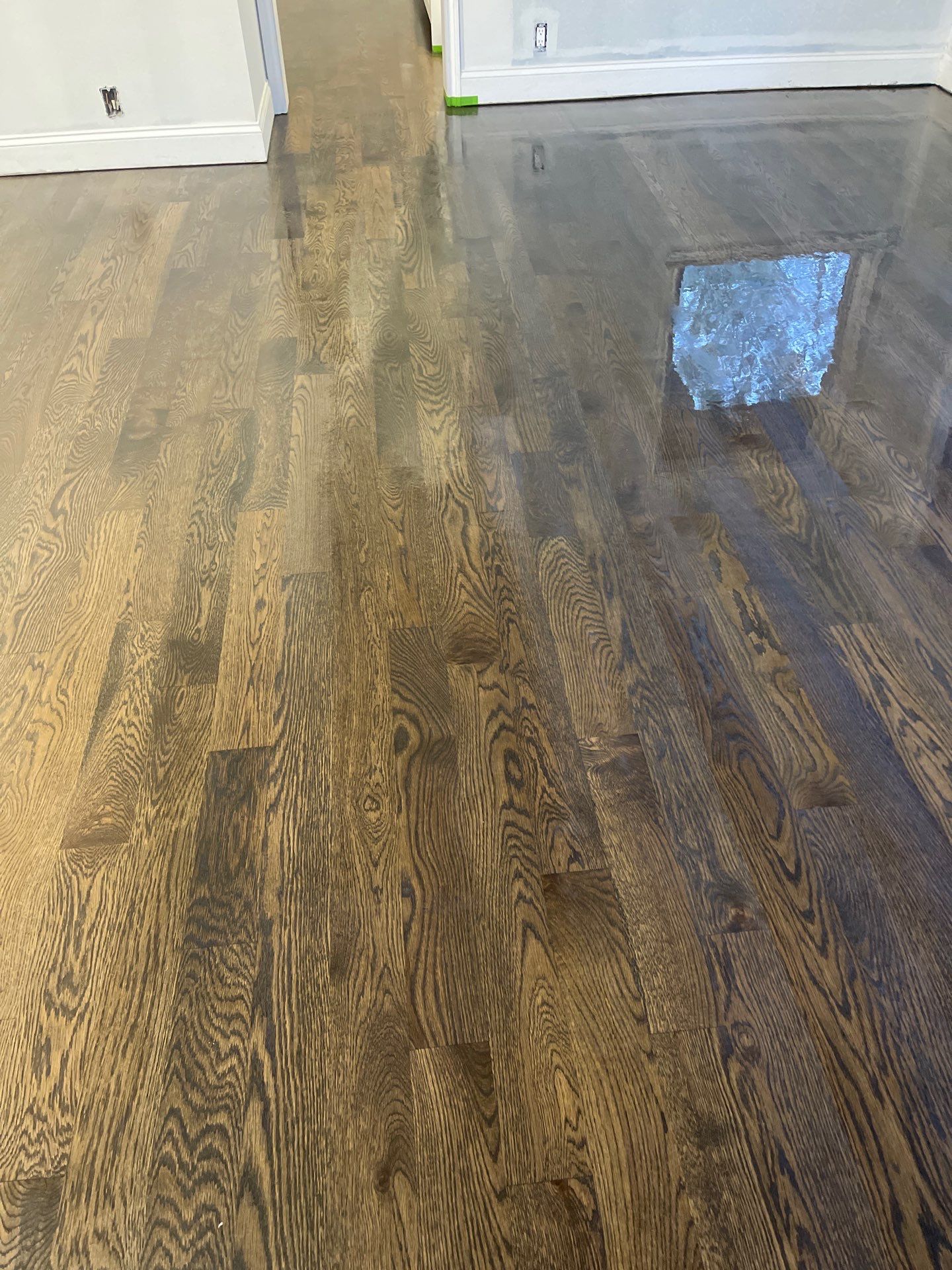 New Flooring installation using 4" White oak select grade plain sawn Ebony Stain by Ann Arbor Hardwoods