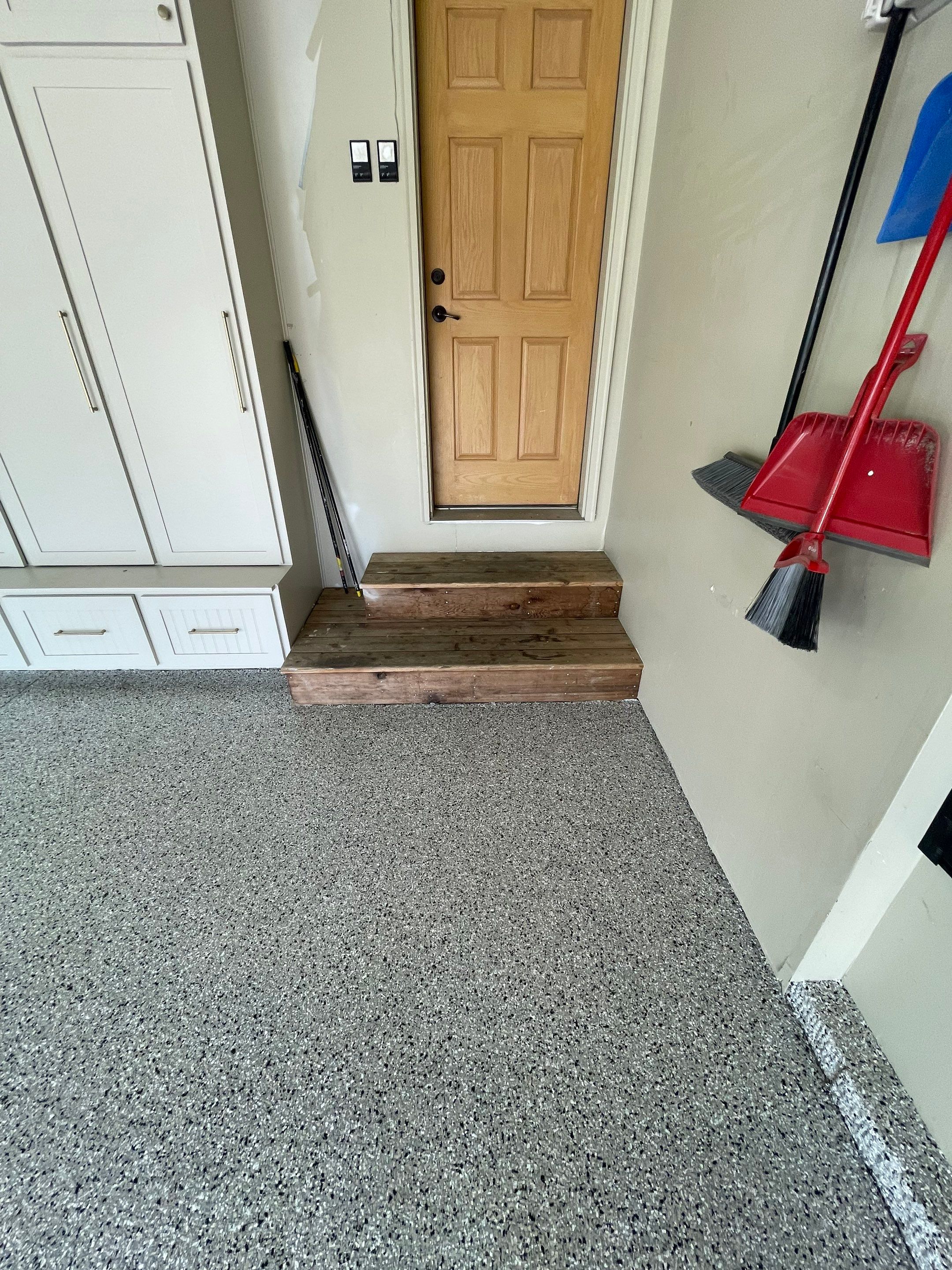 Cabin FEver Flake Garage Floor Coating Installation in Sioux Falls by Select Painting, Coatings & Garage Cabinets