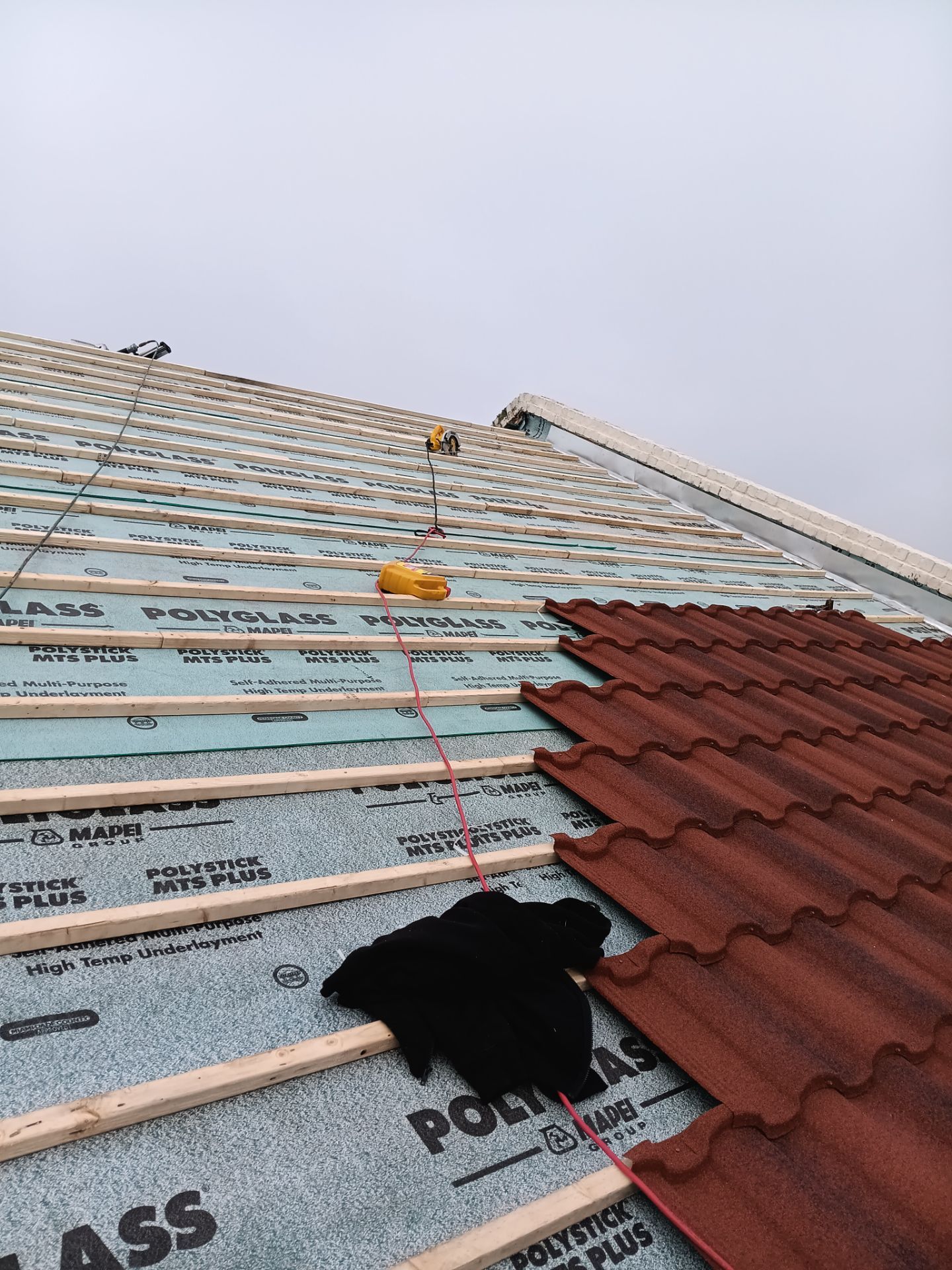 Off with the Tile and on with the TILCOR stone coated metal.  by Bayfront Roofing and Construction