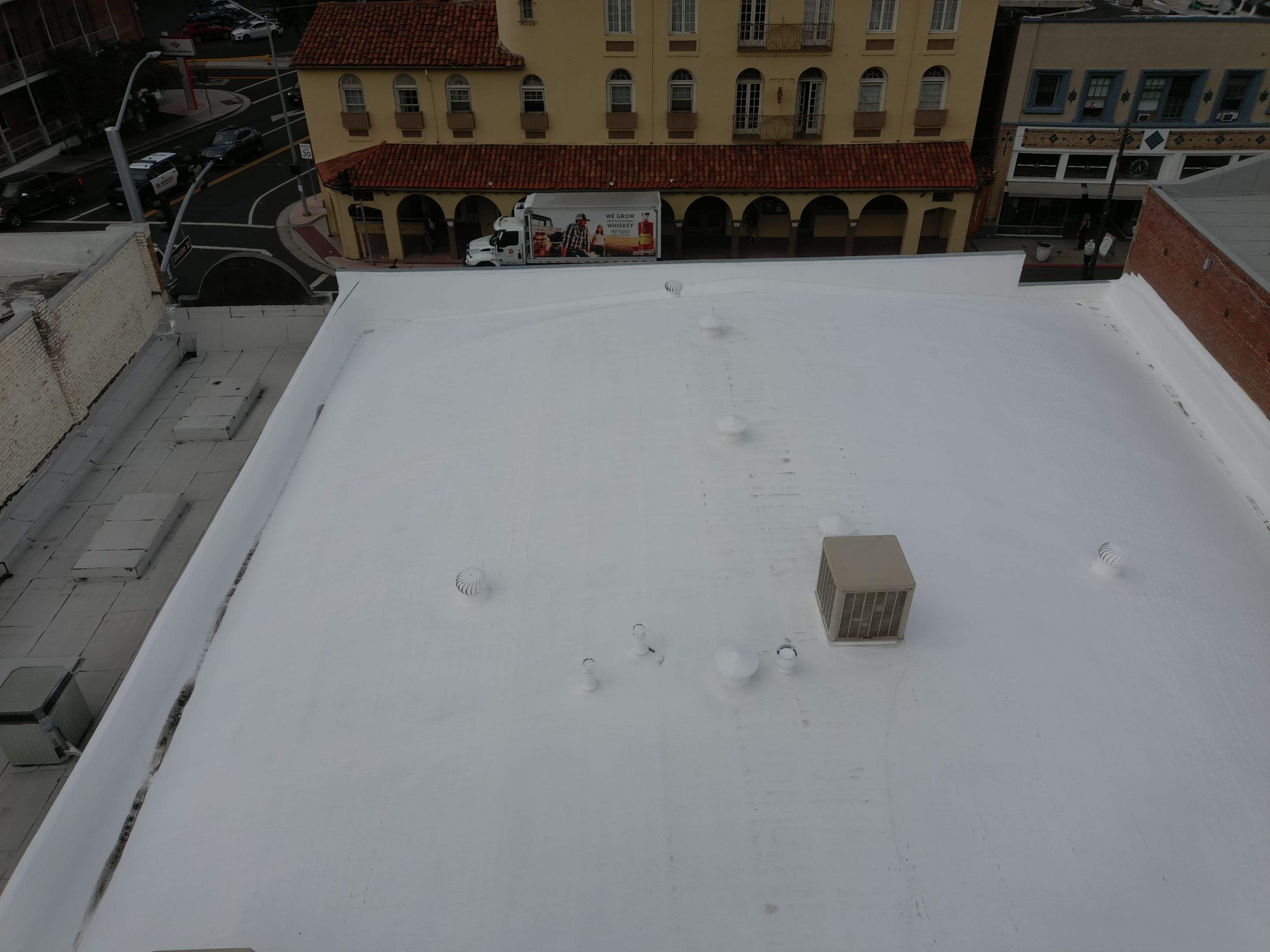 Foam and coatings on commercial roof by Straight Edge Roofing Inc