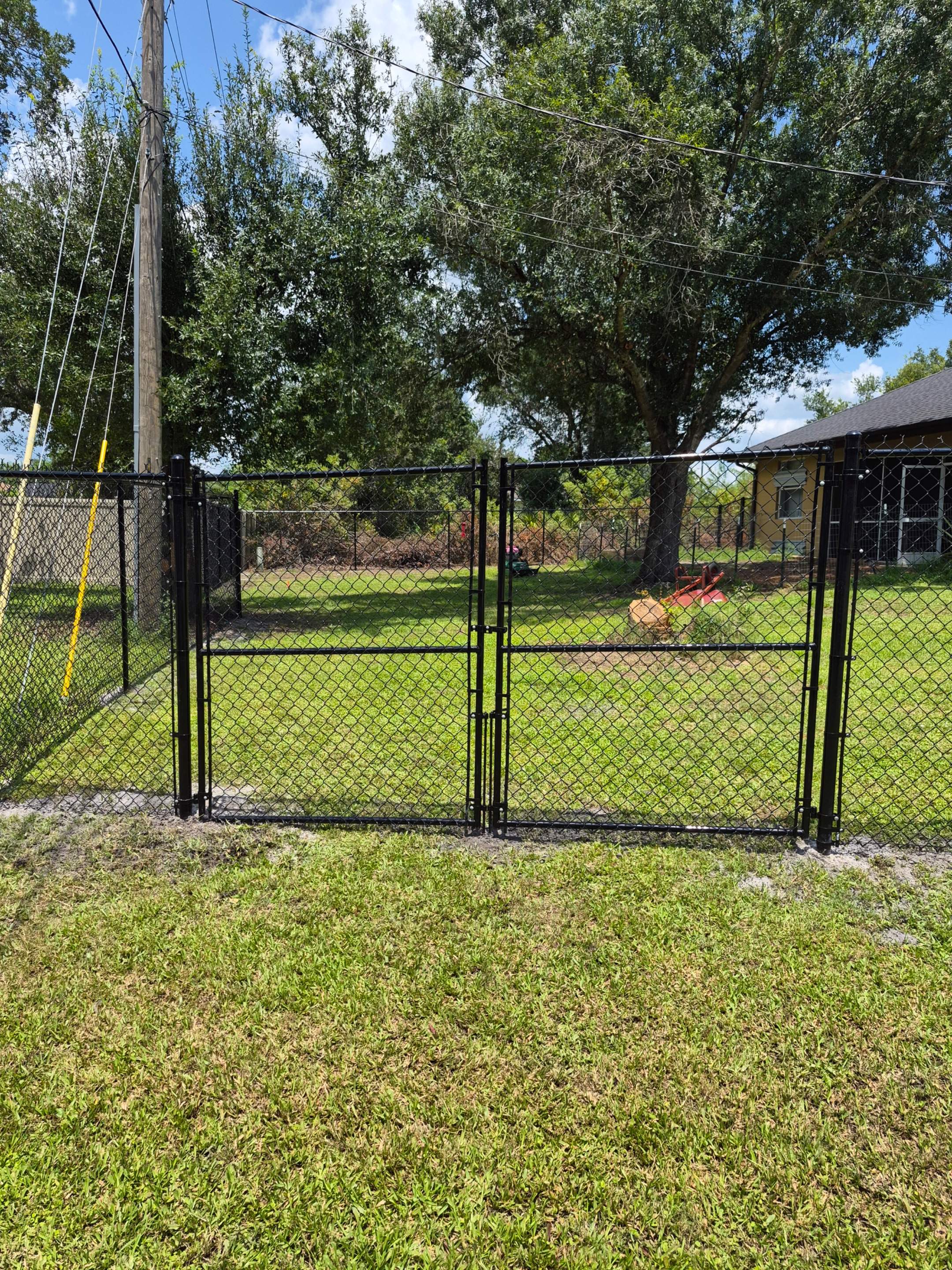 Black Chain Link Perimeter Fencing with Double Gates in Port Charlotte by True Fence LLC