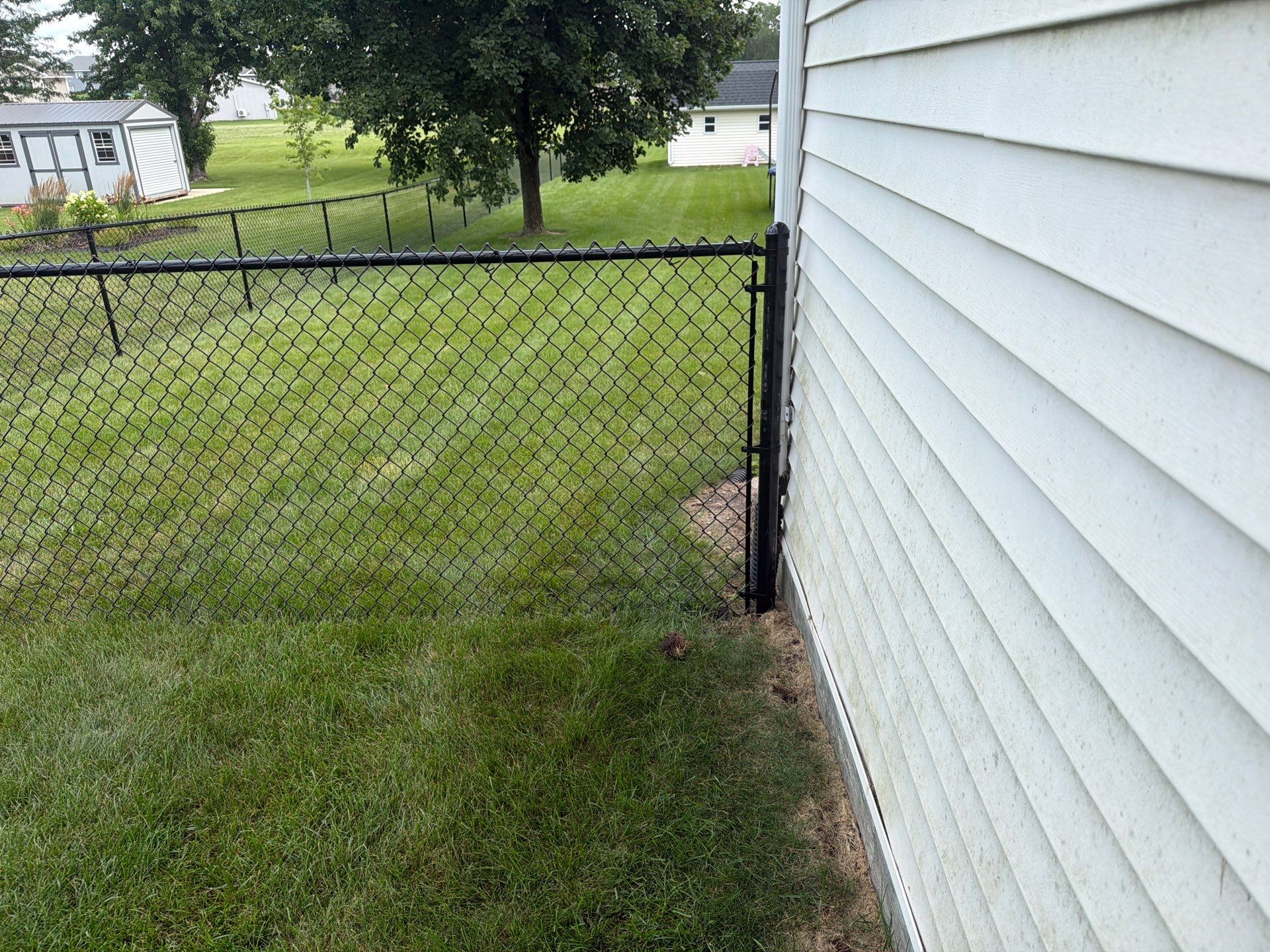 Black Vinyl-Coated Chain Link Fence Installation in Fairbank by Perfect Picket Fence and Stain