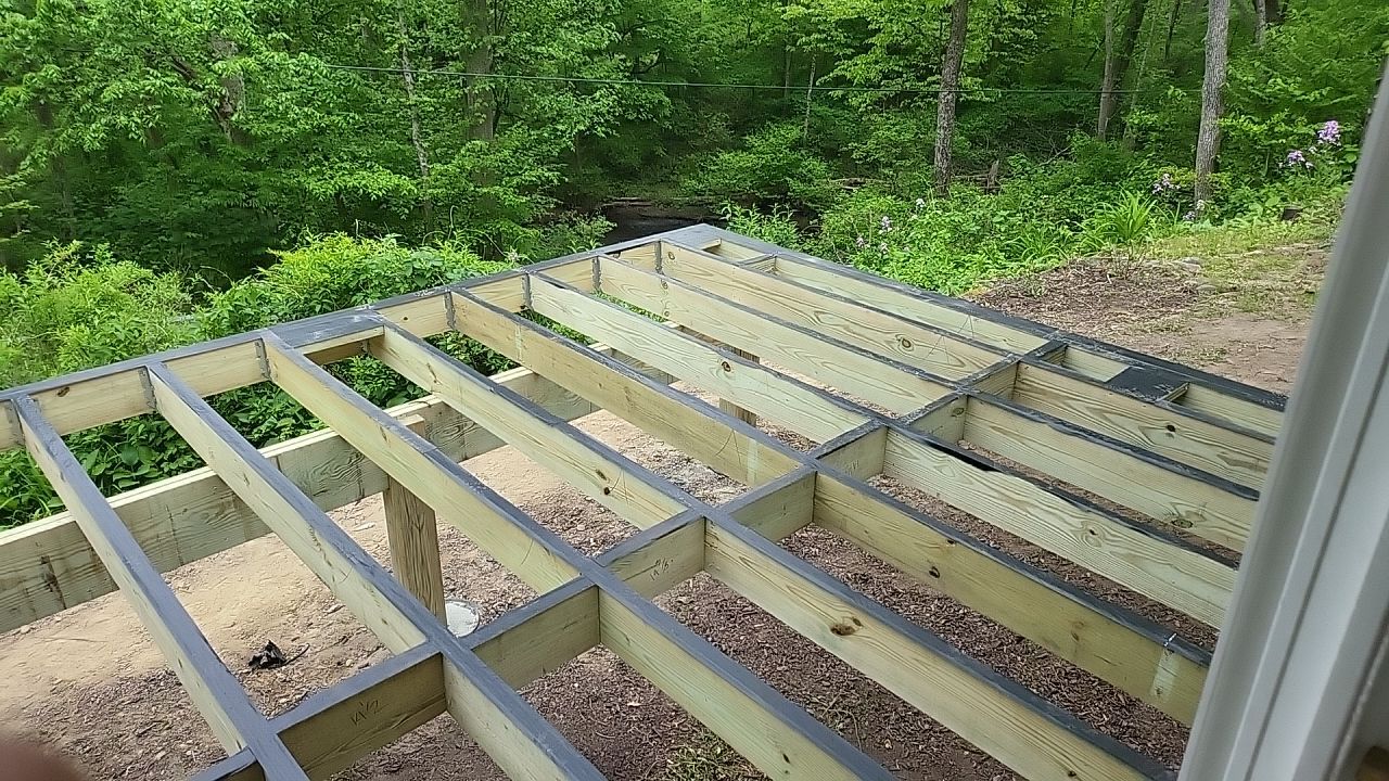 Deck installation using cable railing. by Burke Home Services