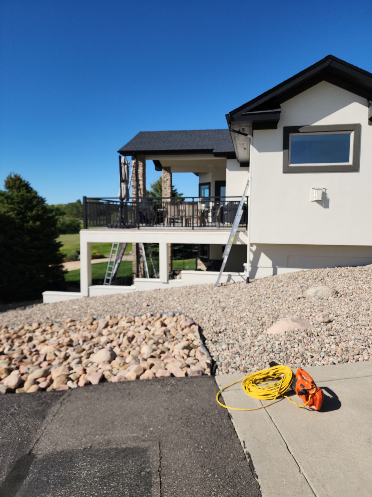 Castle Rock Elegance: White Stucco Exterior with Bold Tricorn Black by J&M Painting LLC