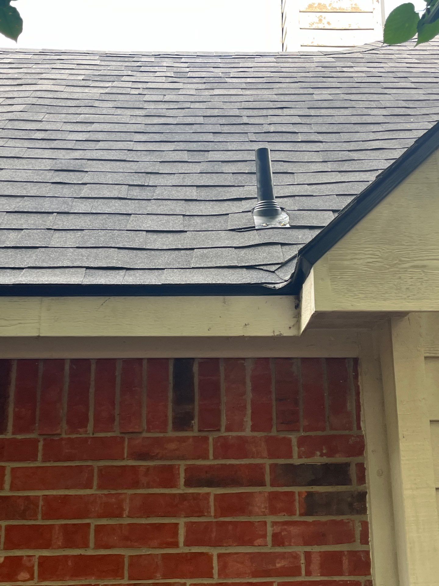 Red brick with Malarkey Midnight Black  by Tejas Roofworks + Restoration