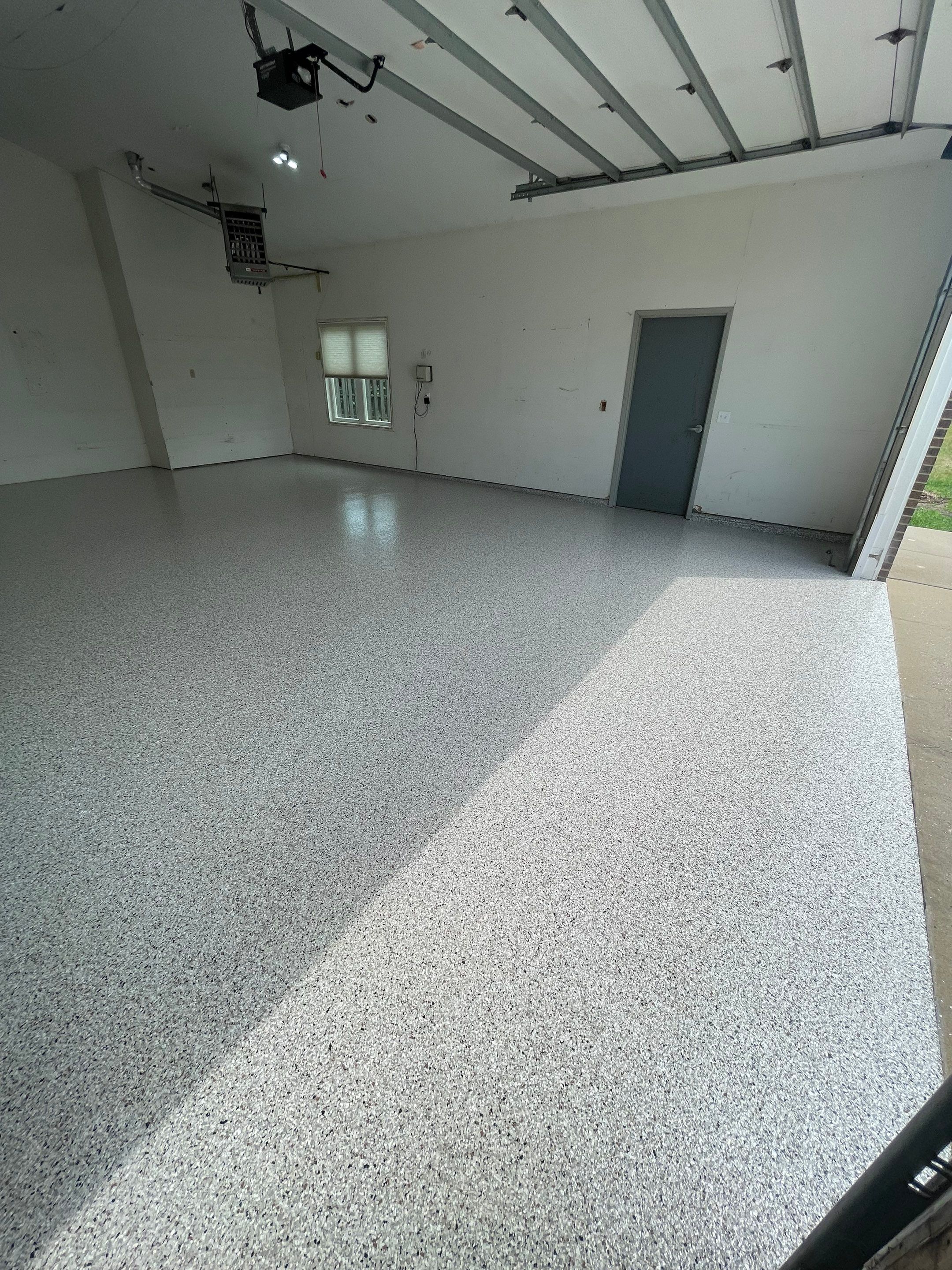 Coyote Flake Concrete Coating for Sioux Falls Garage by Select Painting, Coatings & Garage Cabinets