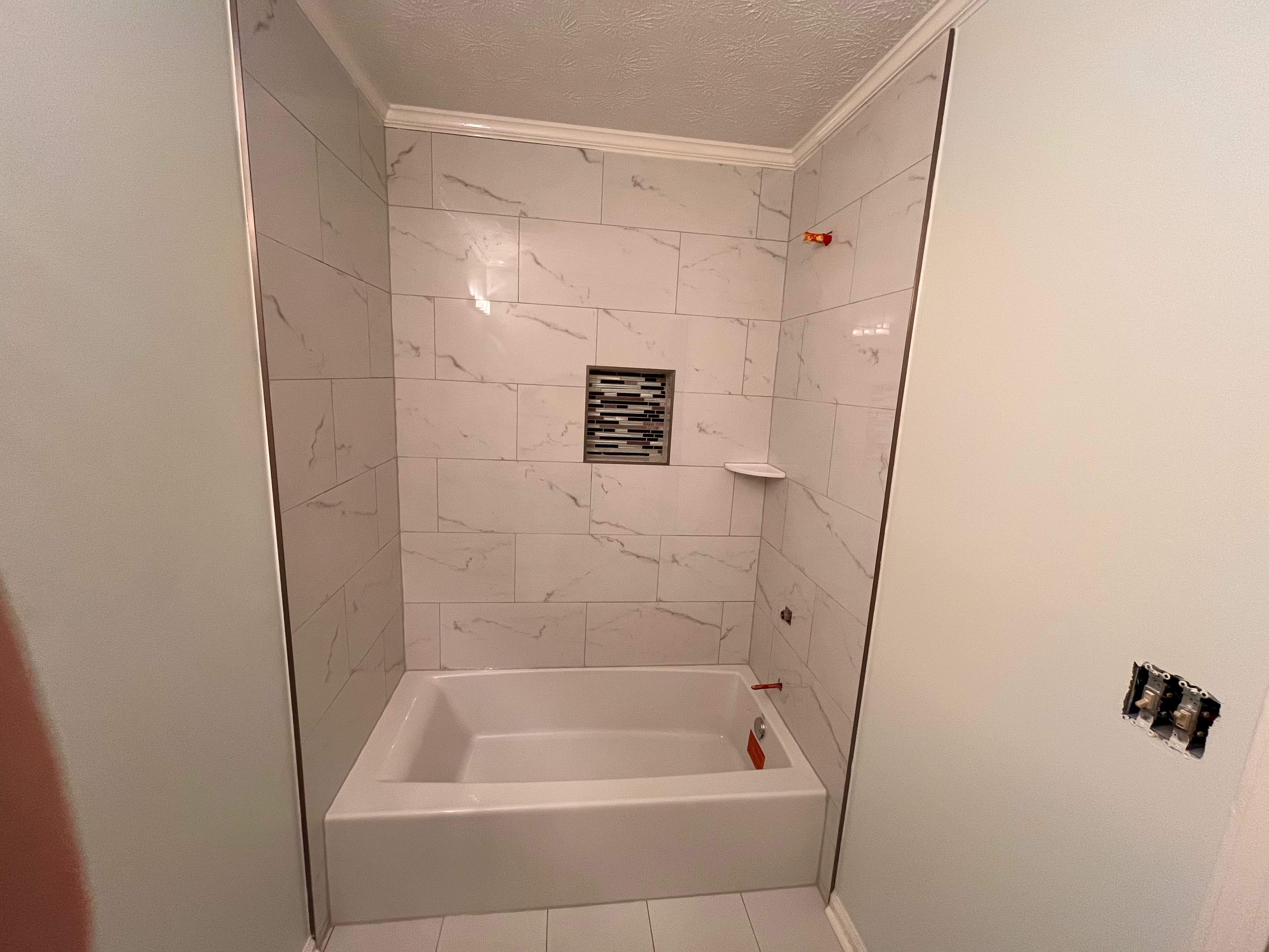 Guest bathroom tub and flooring by Prudencio