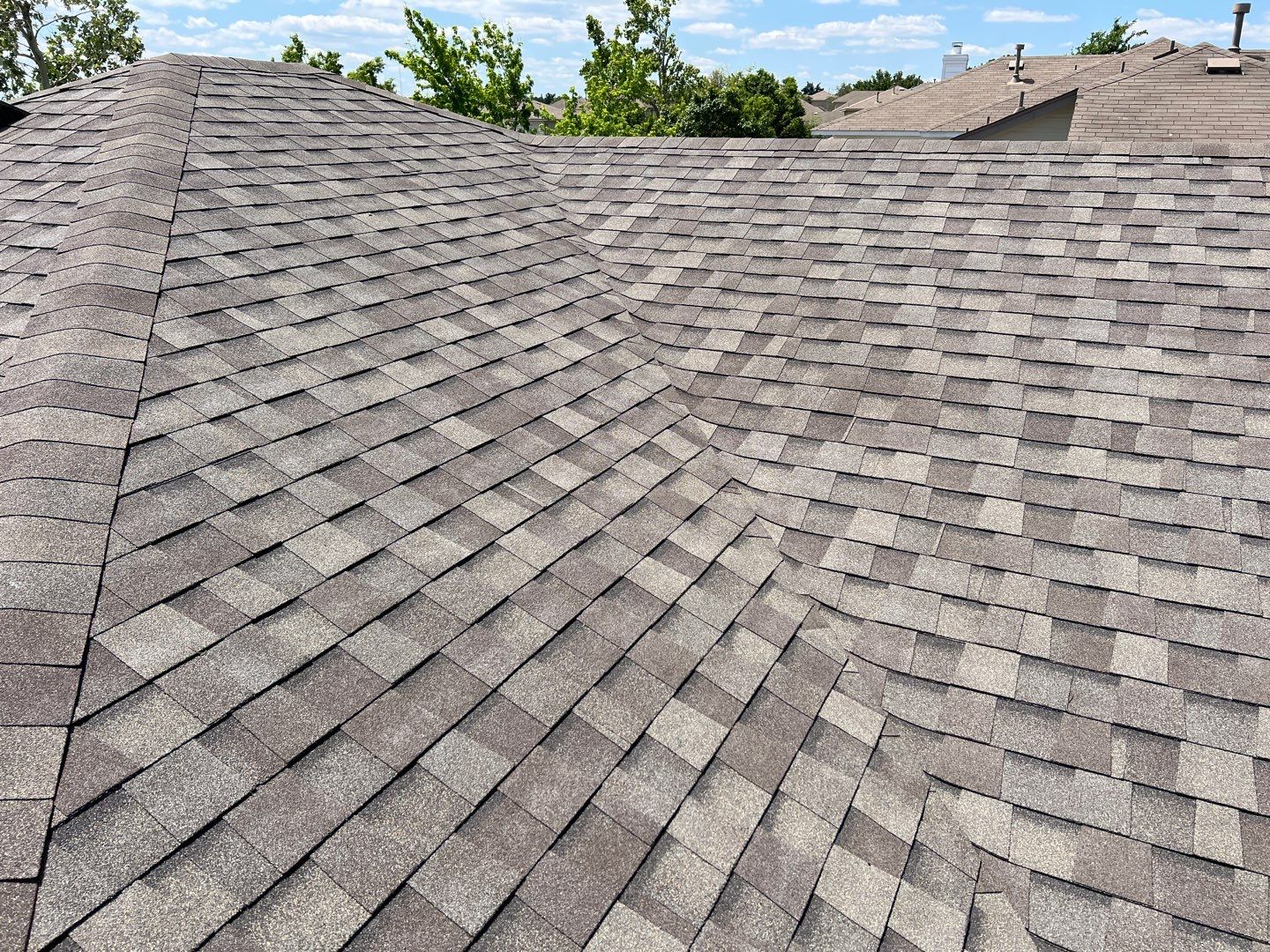 Wind damaged roof replacement by Oakwood Roofing and Construction, LLC