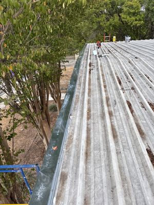 Metal roof panels with sealant tube and debris