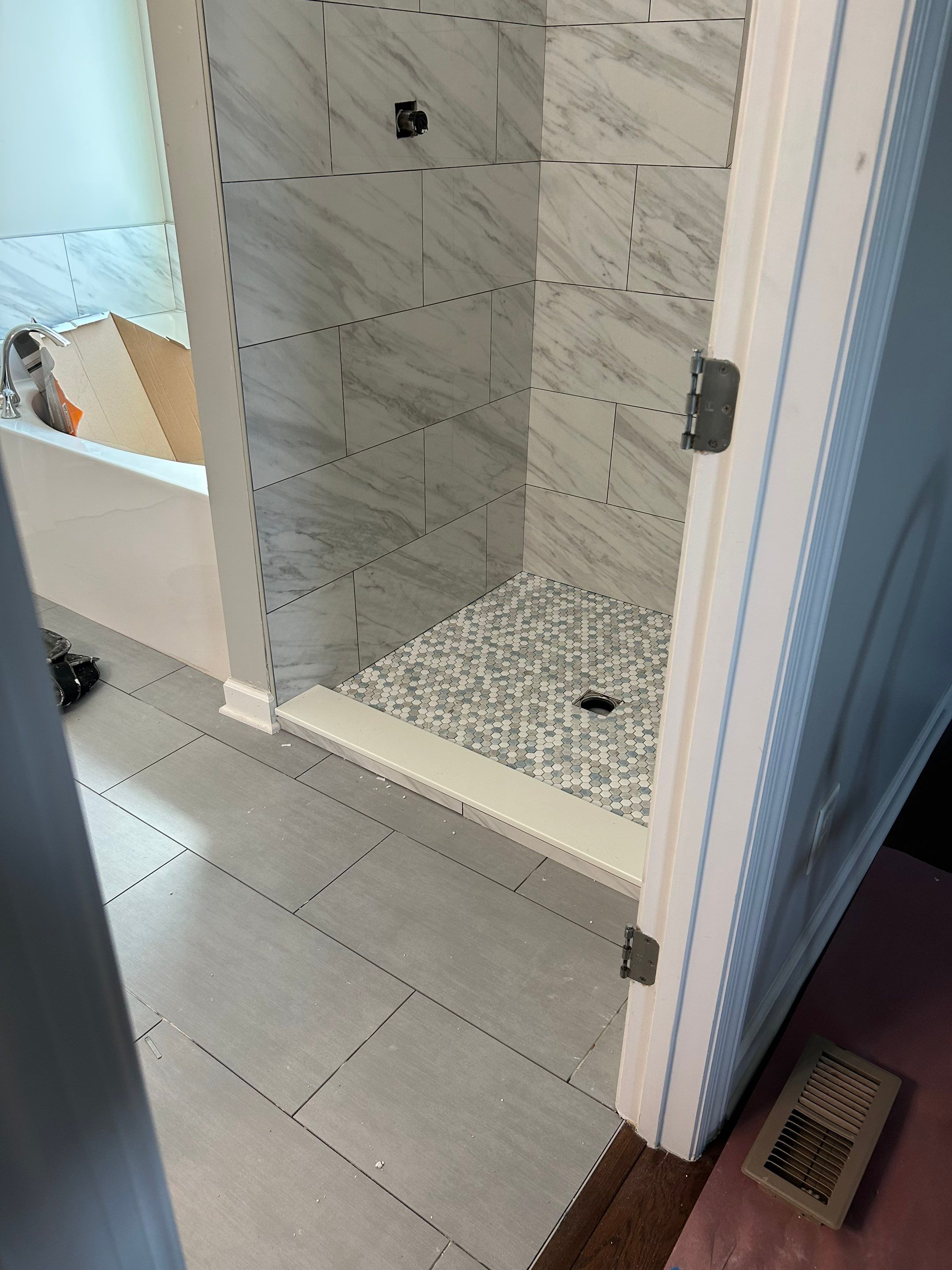 Tile shower remodel and heated floors by Footprints Floors of Nashville