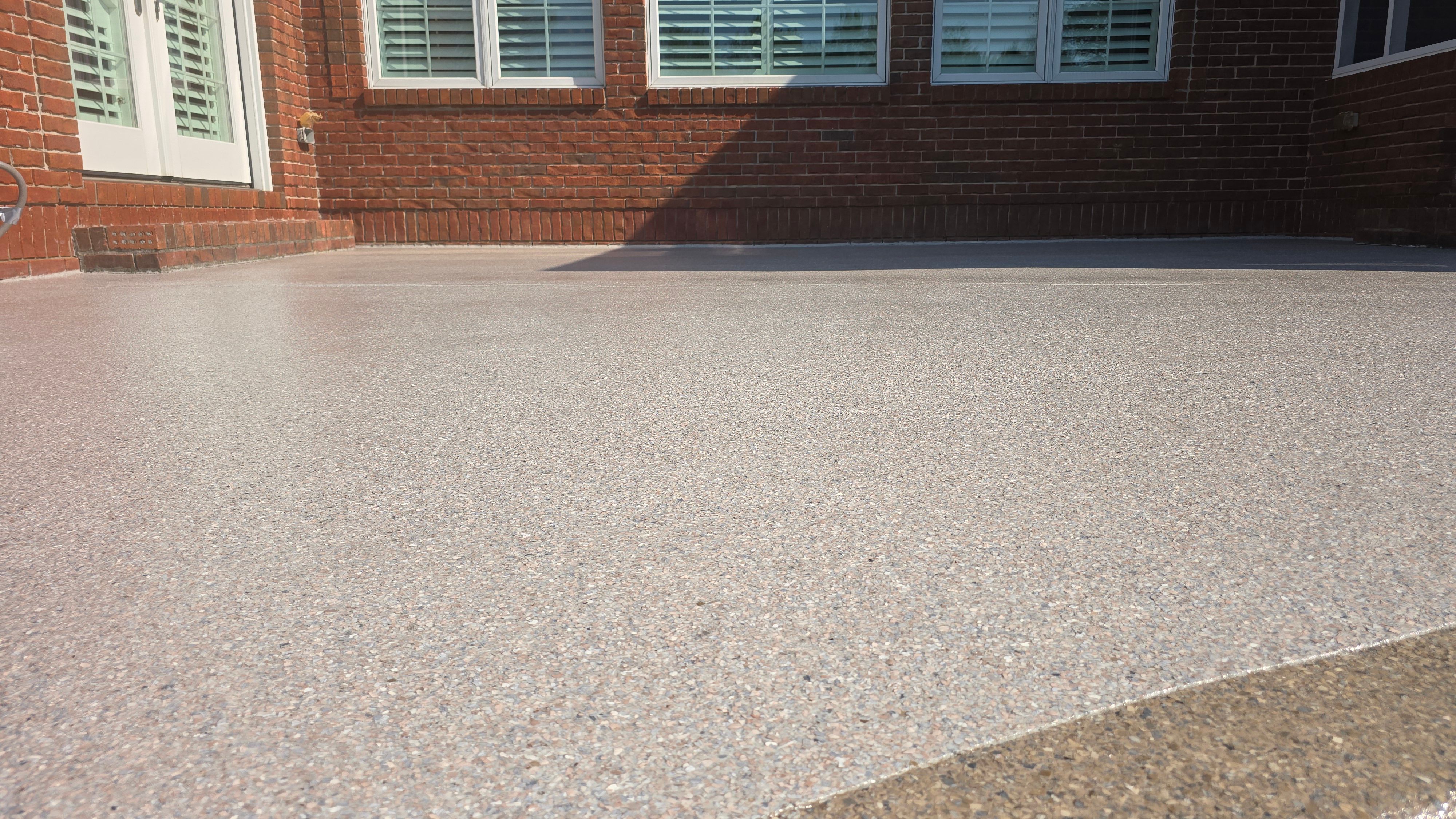 Patio in Pumice with Obsidian Border  by Elite Floor Solutions