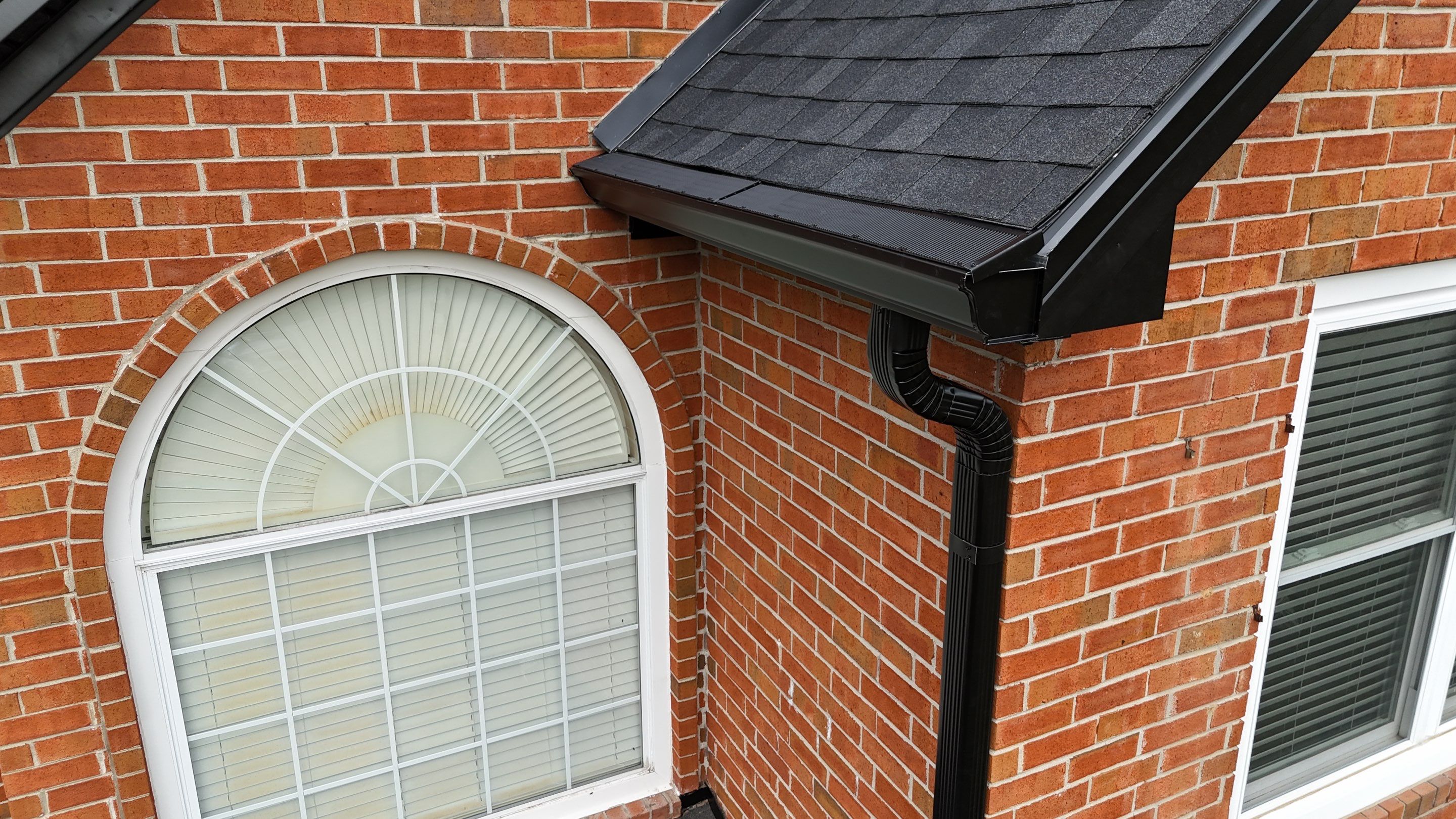 Charcoal Black Re-Roof & Gutters by Royal House LLC