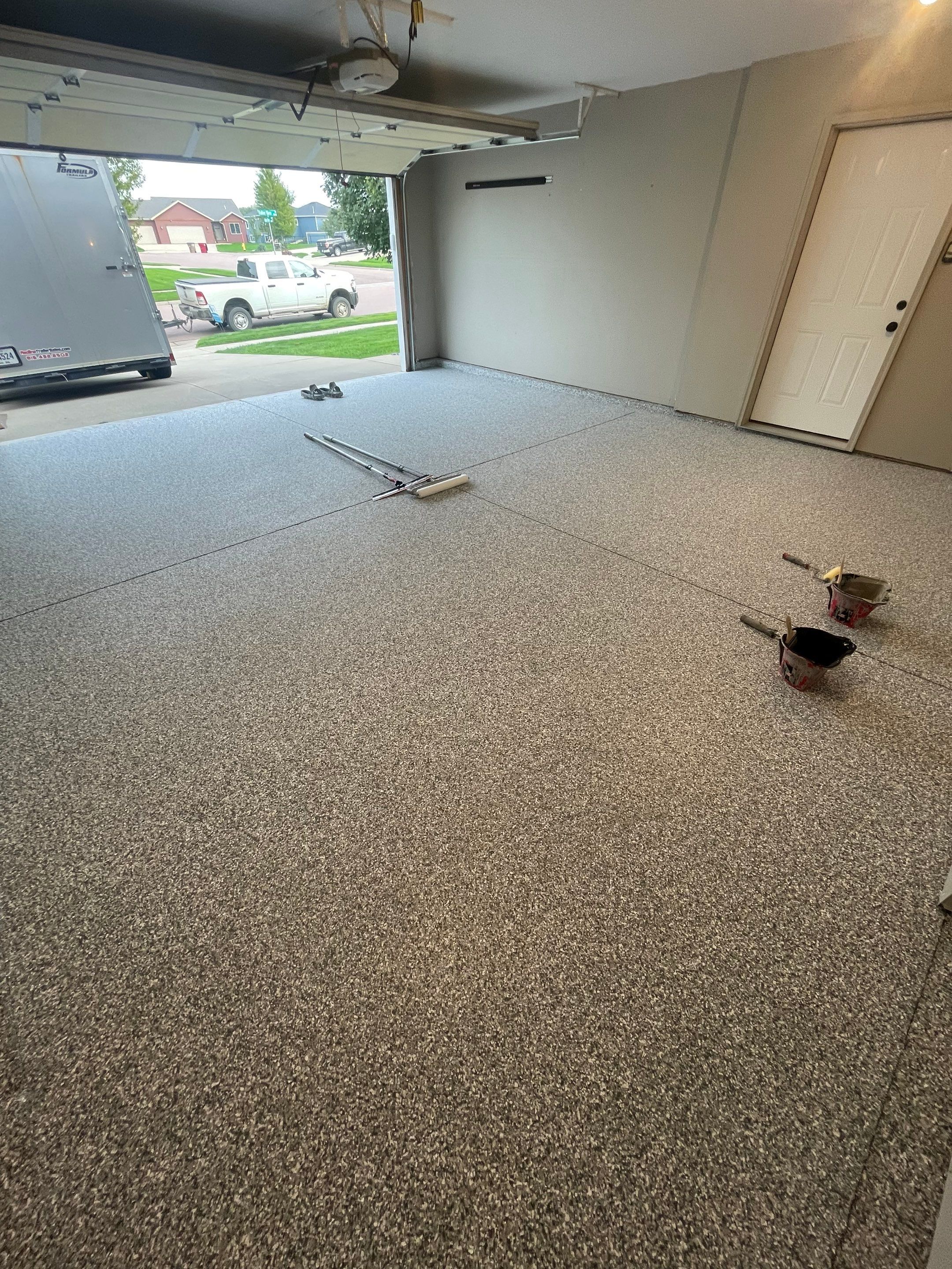 Custom Polyurea Flake Garage Floor Installation in Sioux Falls by Select Painting, Coatings & Garage Cabinets