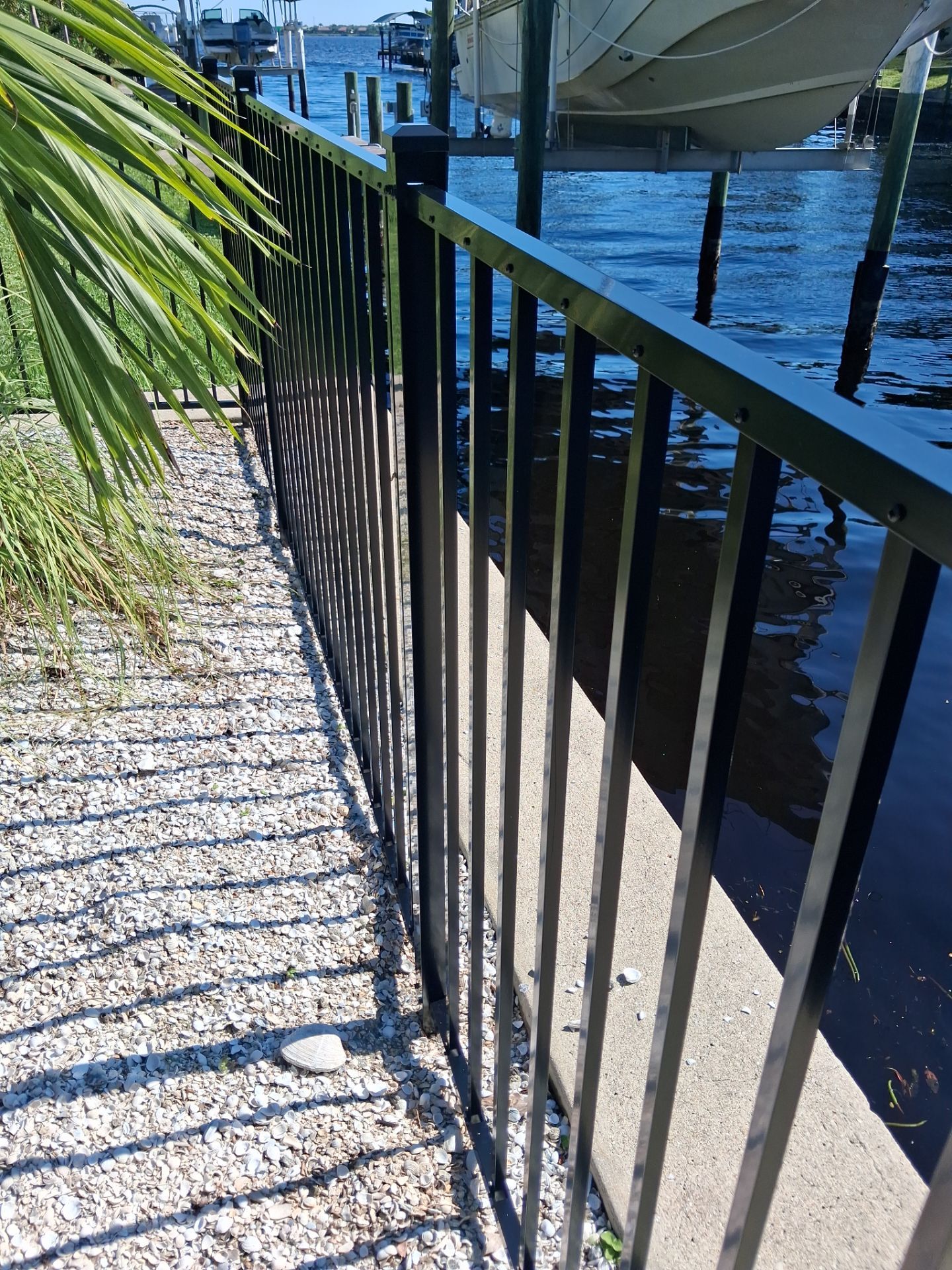 Black Aluminum Picket Fence Installation for Port Charlotte Canal Home by True Fence LLC