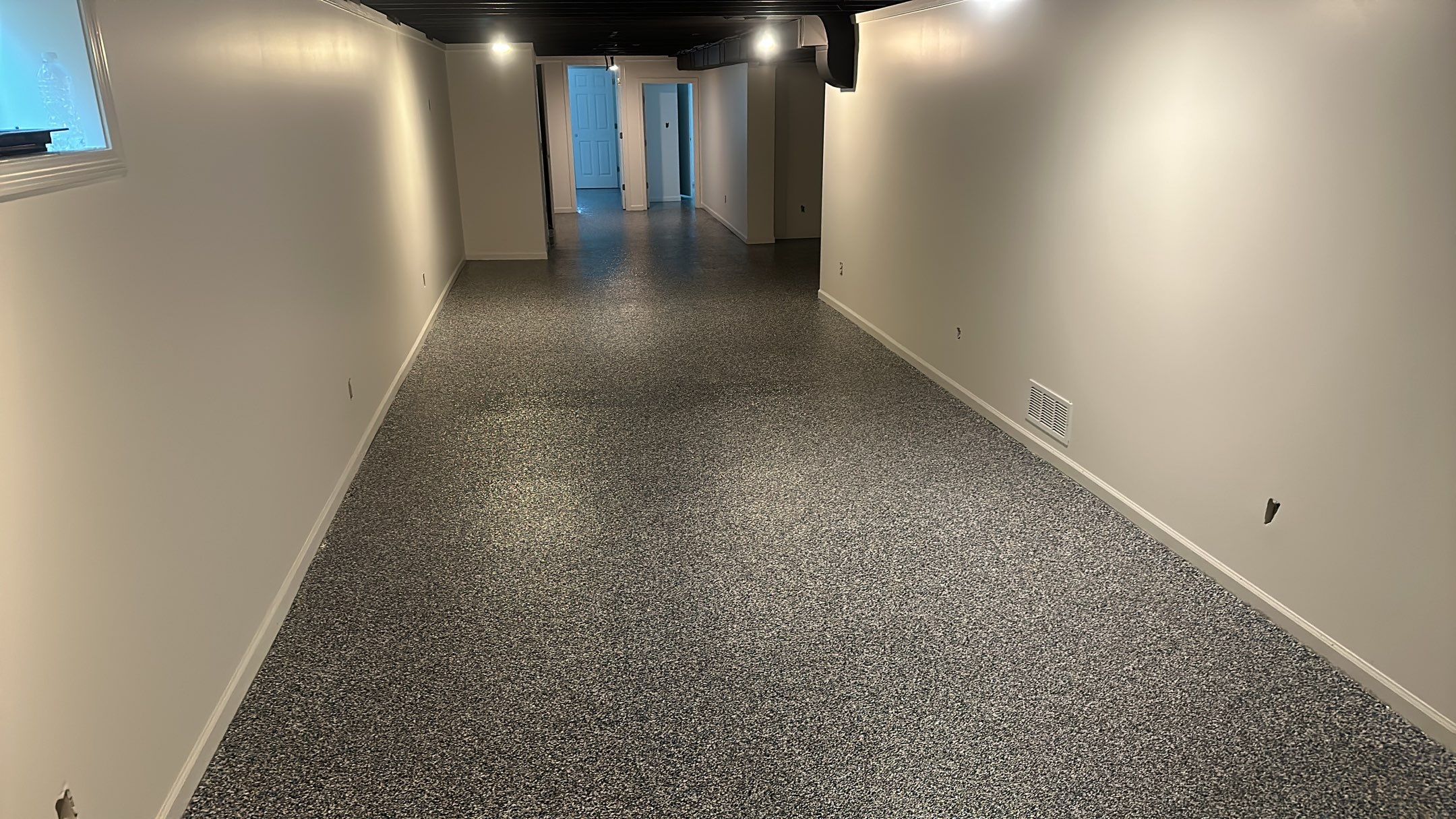 A beautiful Banner Garage Coating in a basement  by Banner Garage