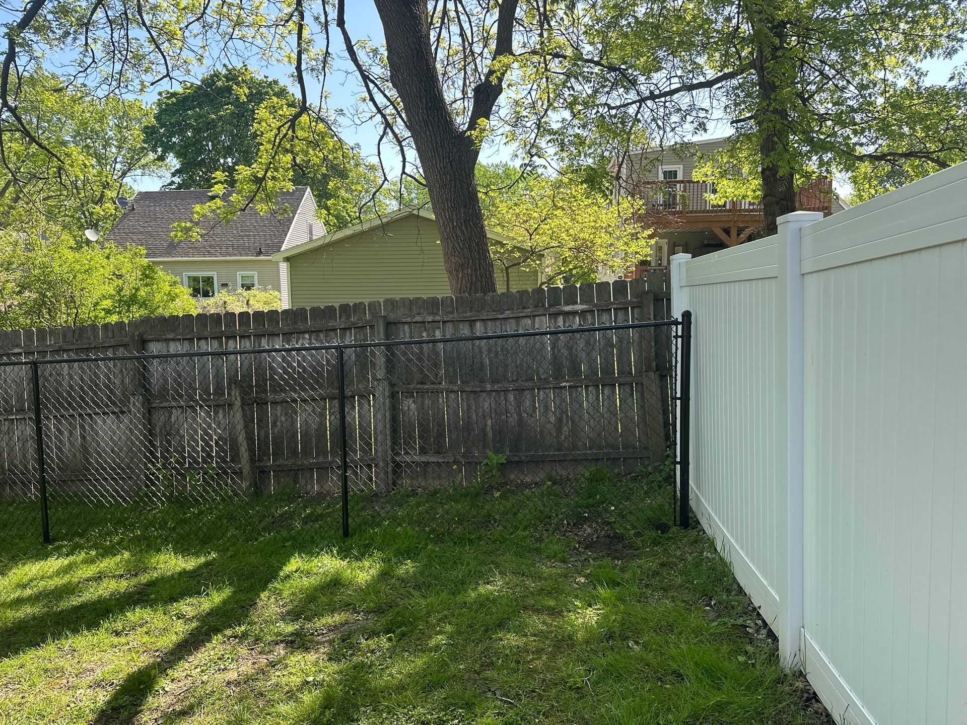 Black Chain Link Fence and Driveway Gate Installation in Waterloo by Perfect Picket Fence and Stain