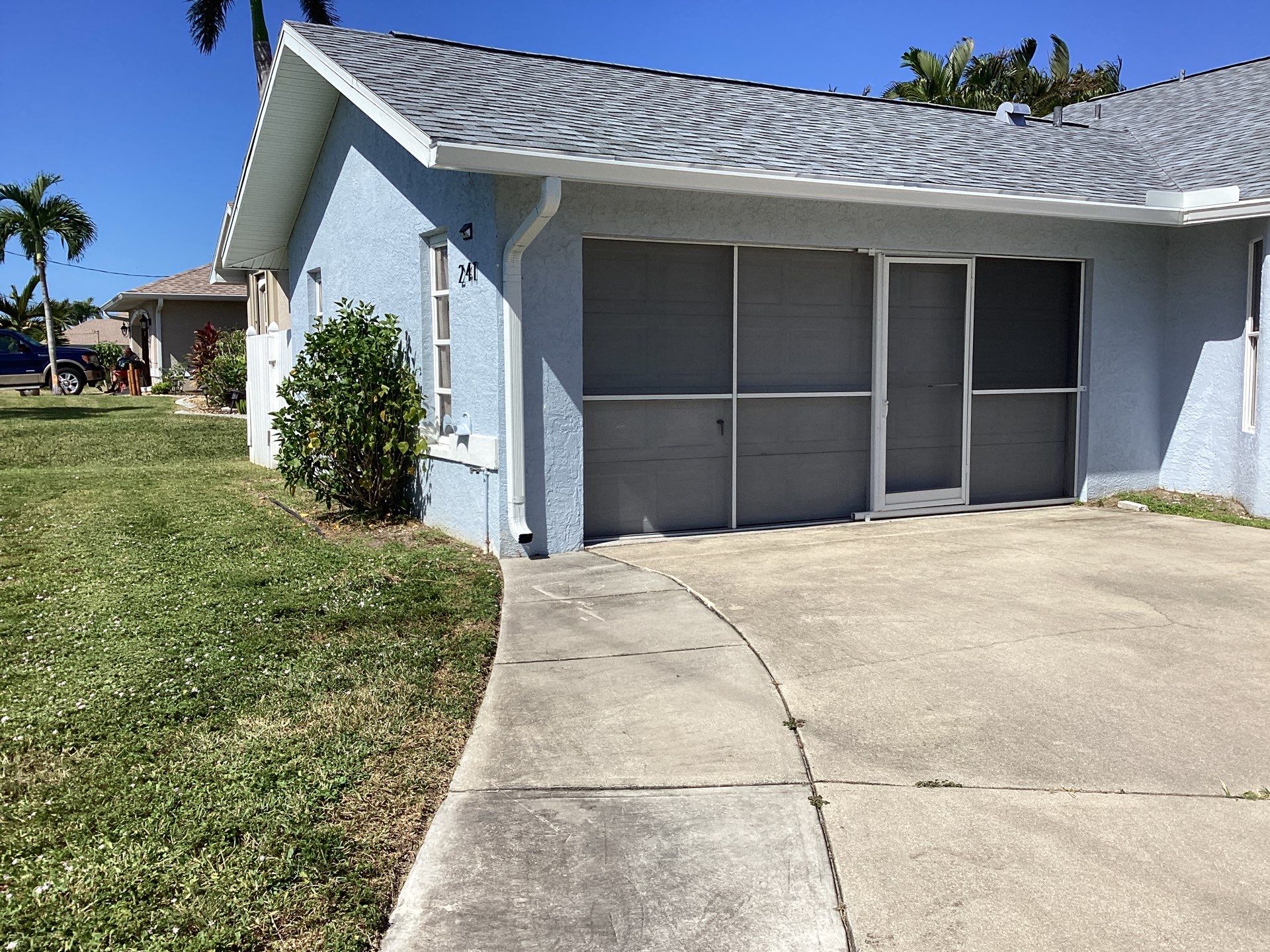 New White Seamless Gutters with Downspouts and Splash Guards in Cape Coral FL by Gutter Professors