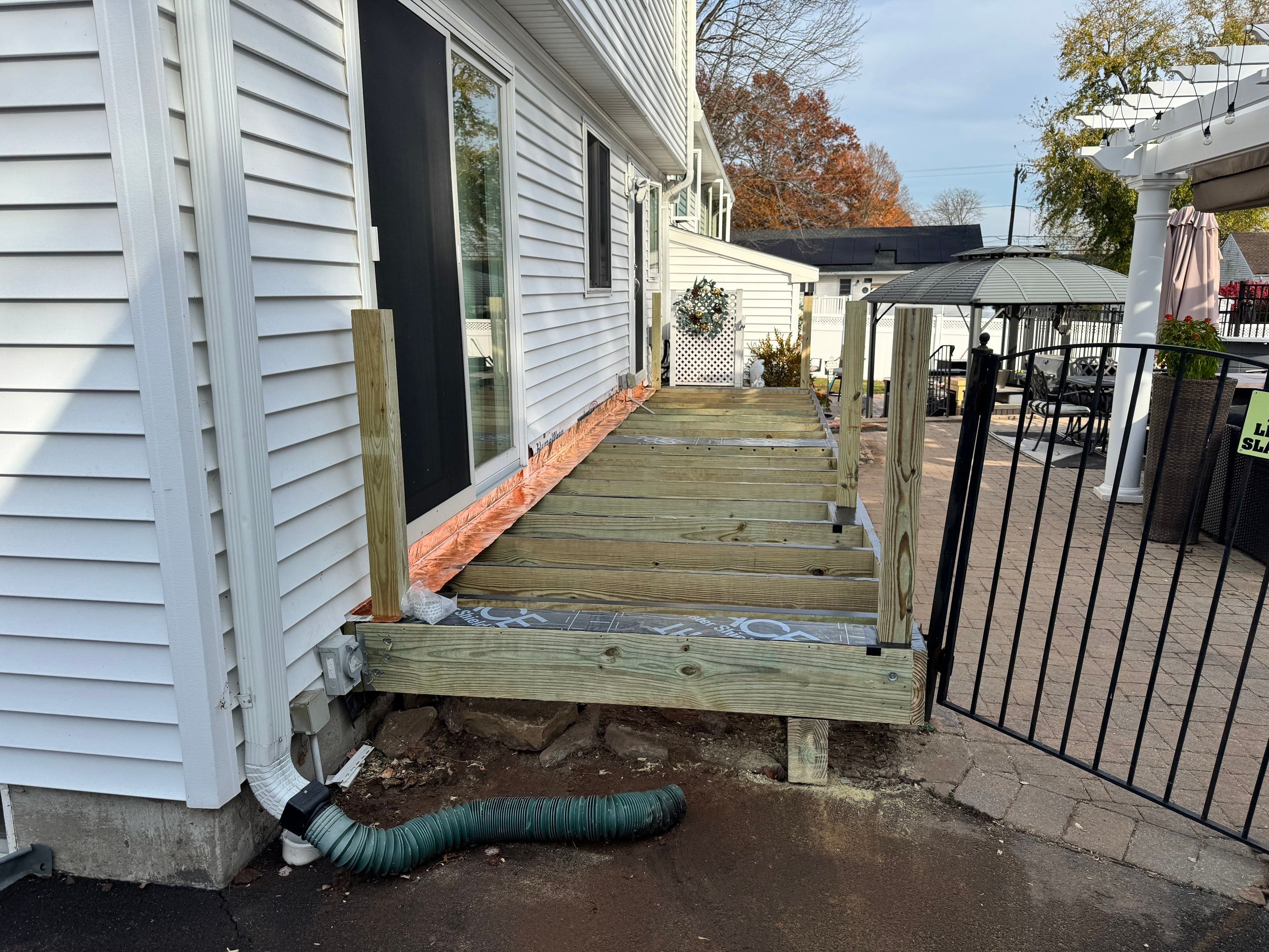 Replacement Deck using Tres Lineage Carmel boards and White Composite railing. by DiGiorgi Roofing and Siding Inc