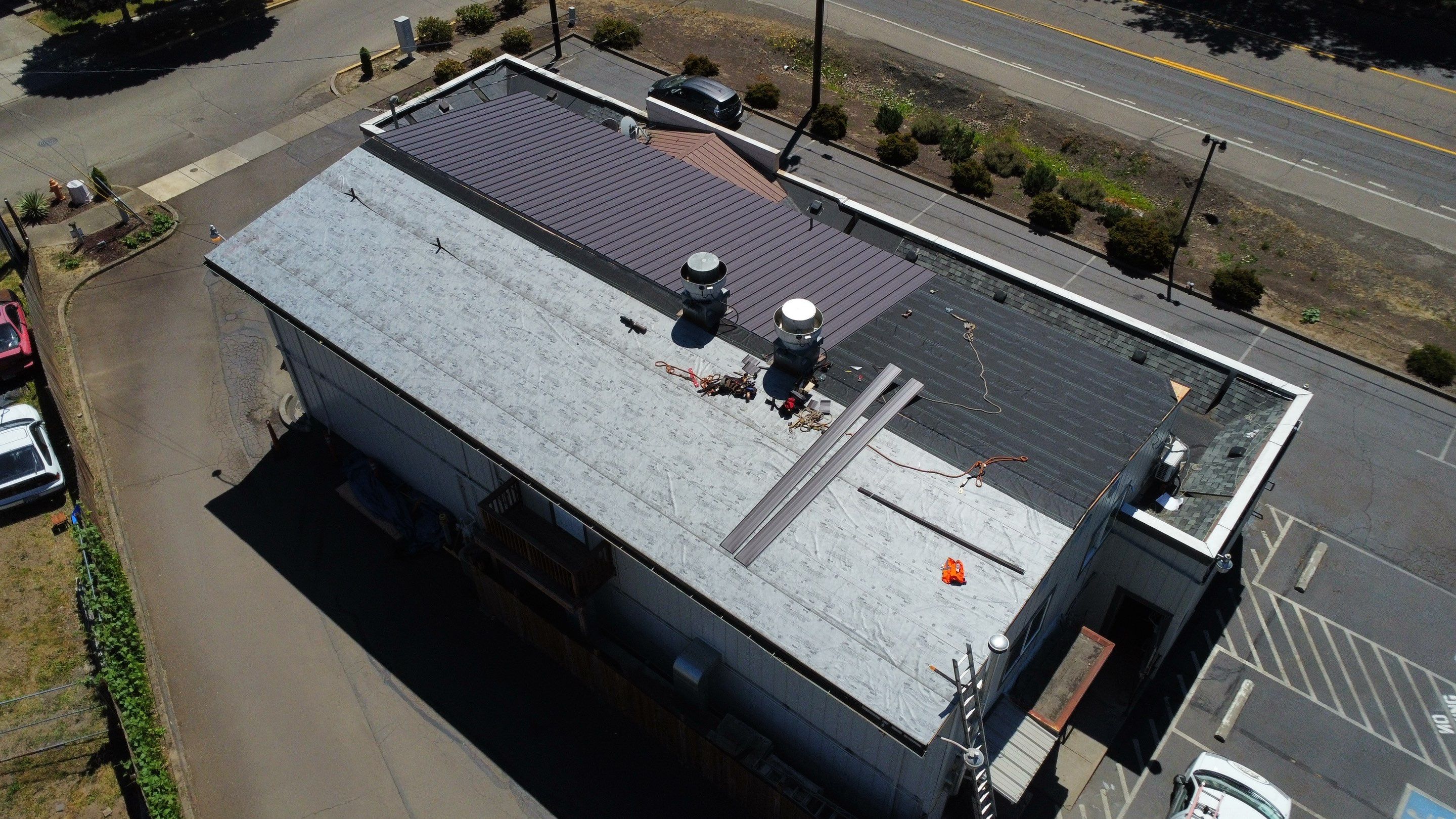 Commercial Flat Roof Installation using Bruce and Dana Snap Lock Metal (Color: Brown) by Orezona Building & Roofing Company, Inc.