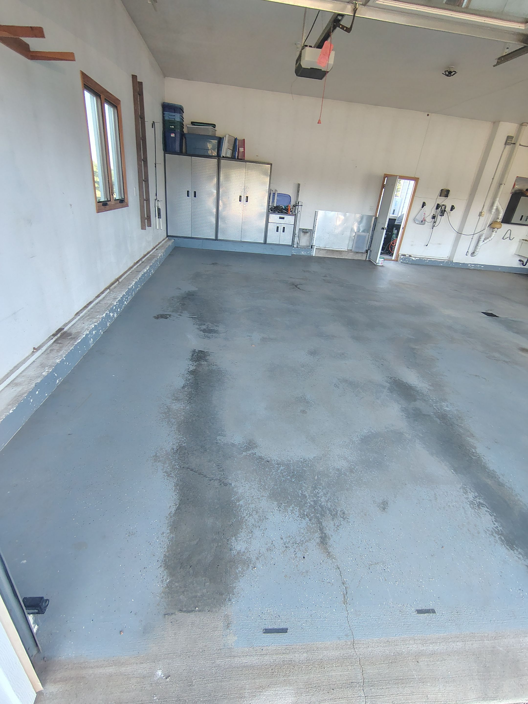 Feather Grey Garage Floor Coating Installation in Valley Springs by Select Painting, Coatings & Garage Cabinets