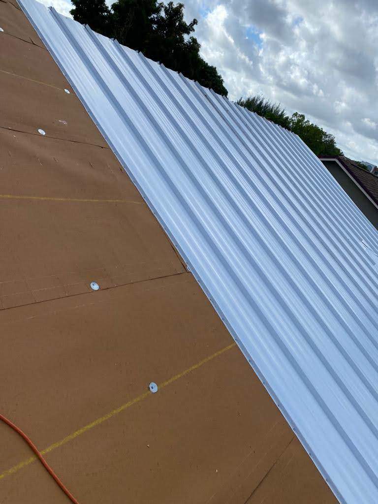 Standing Seam Metal & Flat Re-Roof using 1.5" Nail Strip 24ga Solar White Kynar Coated Standing Seam Metal Panels by Morton Roofing, Inc.