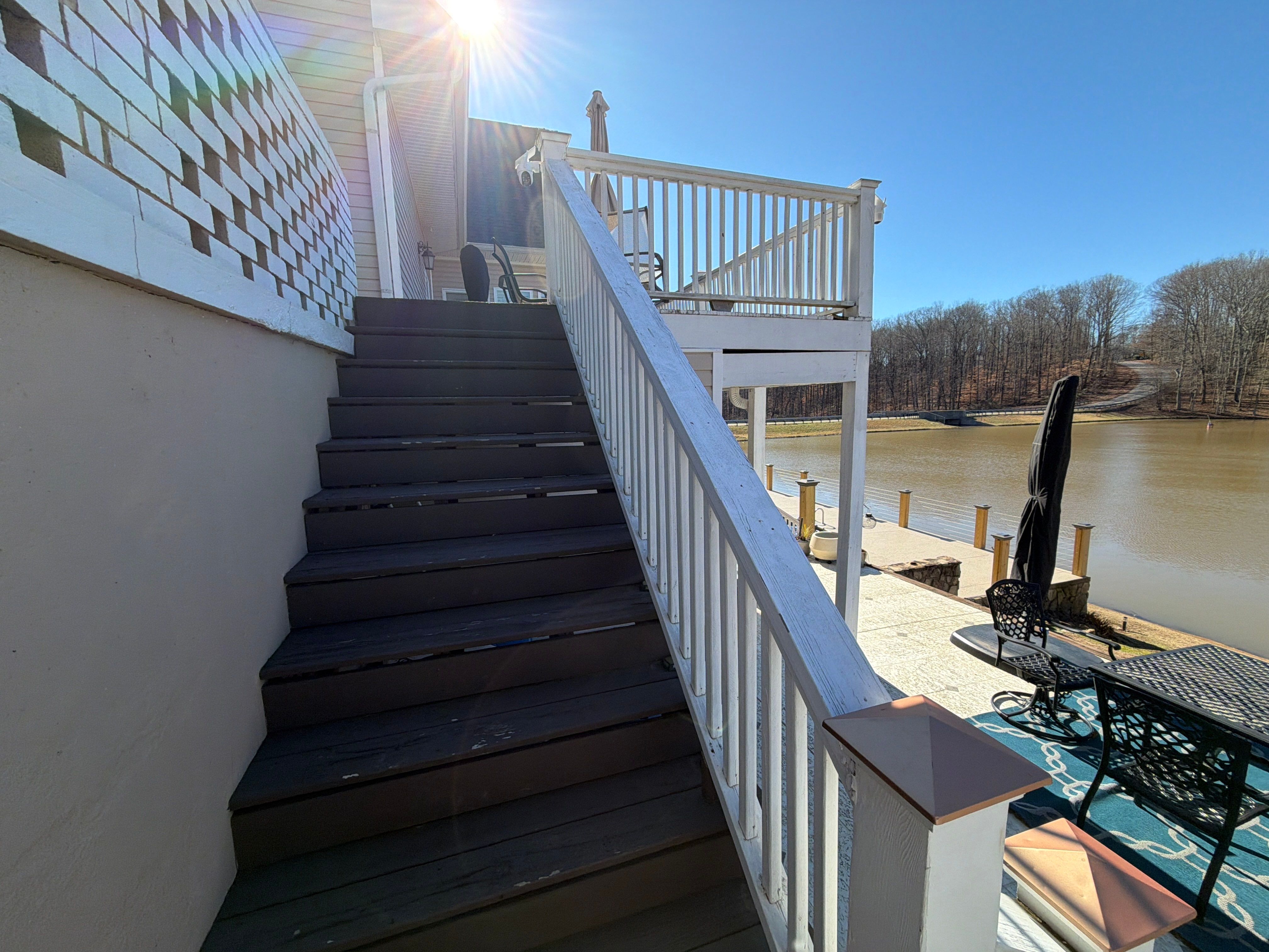 Cumming, GA Lake House Deck Resurface and Extension using Pressure Treated Pine and Skyline Cable Railing by Nelson Exteriors 