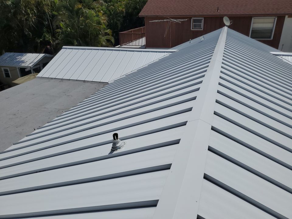 Residential Roofing Installation using 1.5" Nail Strip 24ga Solar White Kynar Coated Standing Seam Metal Panels by Morton Roofing, Inc.