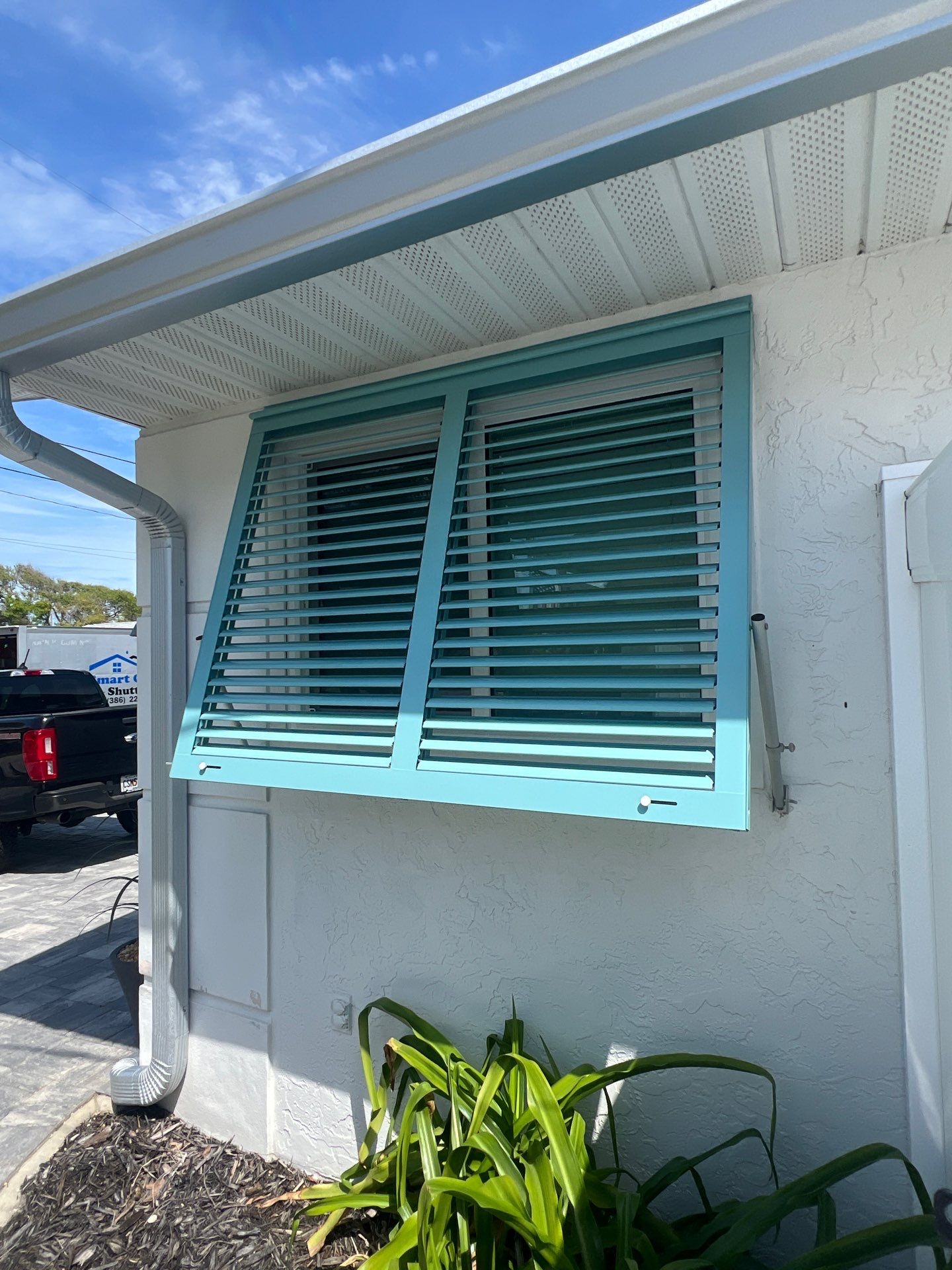 Hurricane Rated Bahama Shutters in Pastel Turquoise  by Smart Guard Shutters