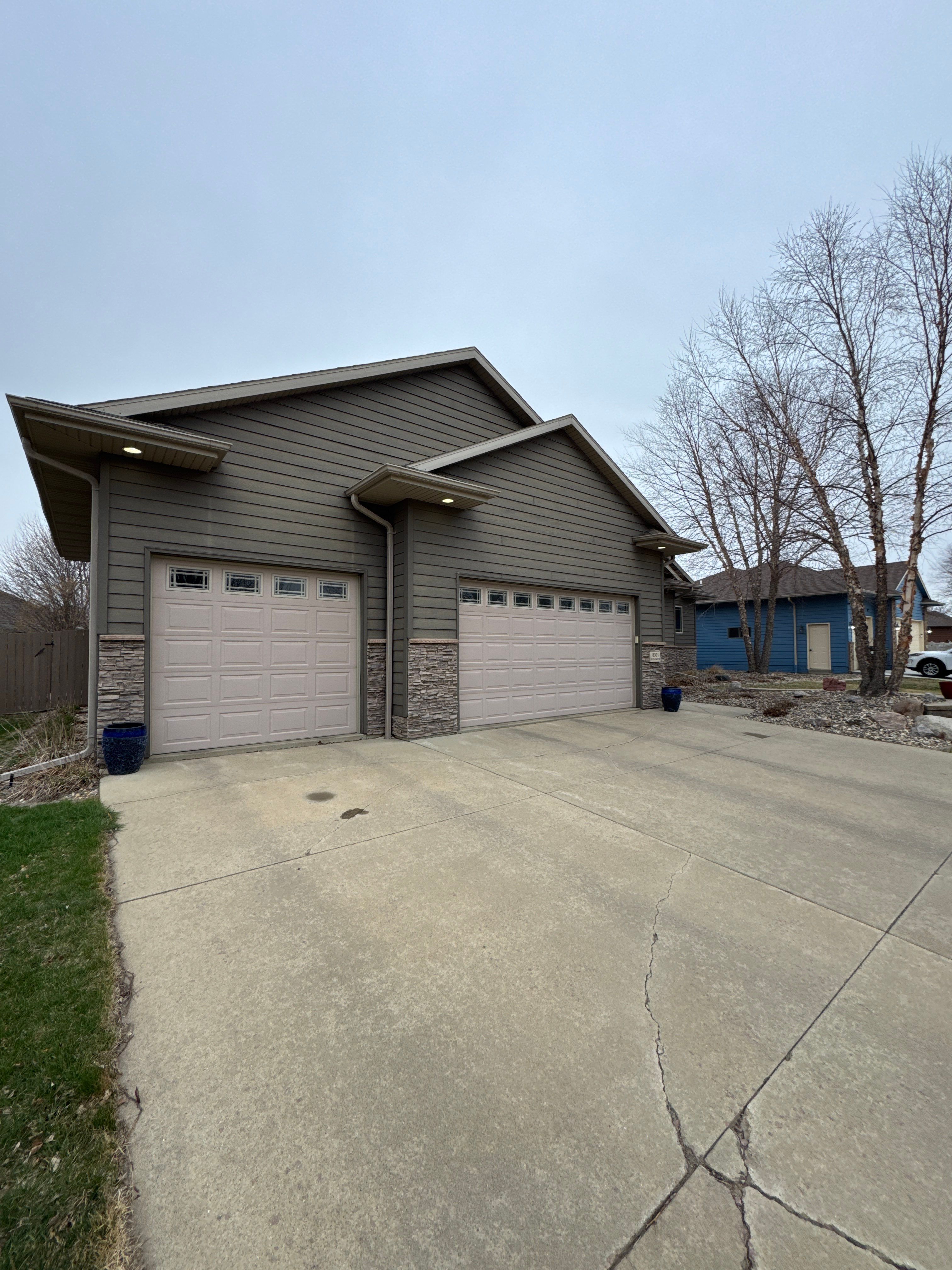 Sioux Falls Residential Exterior Update and Flagstone Pool Deck by Select Painting, Coatings & Garage Cabinets