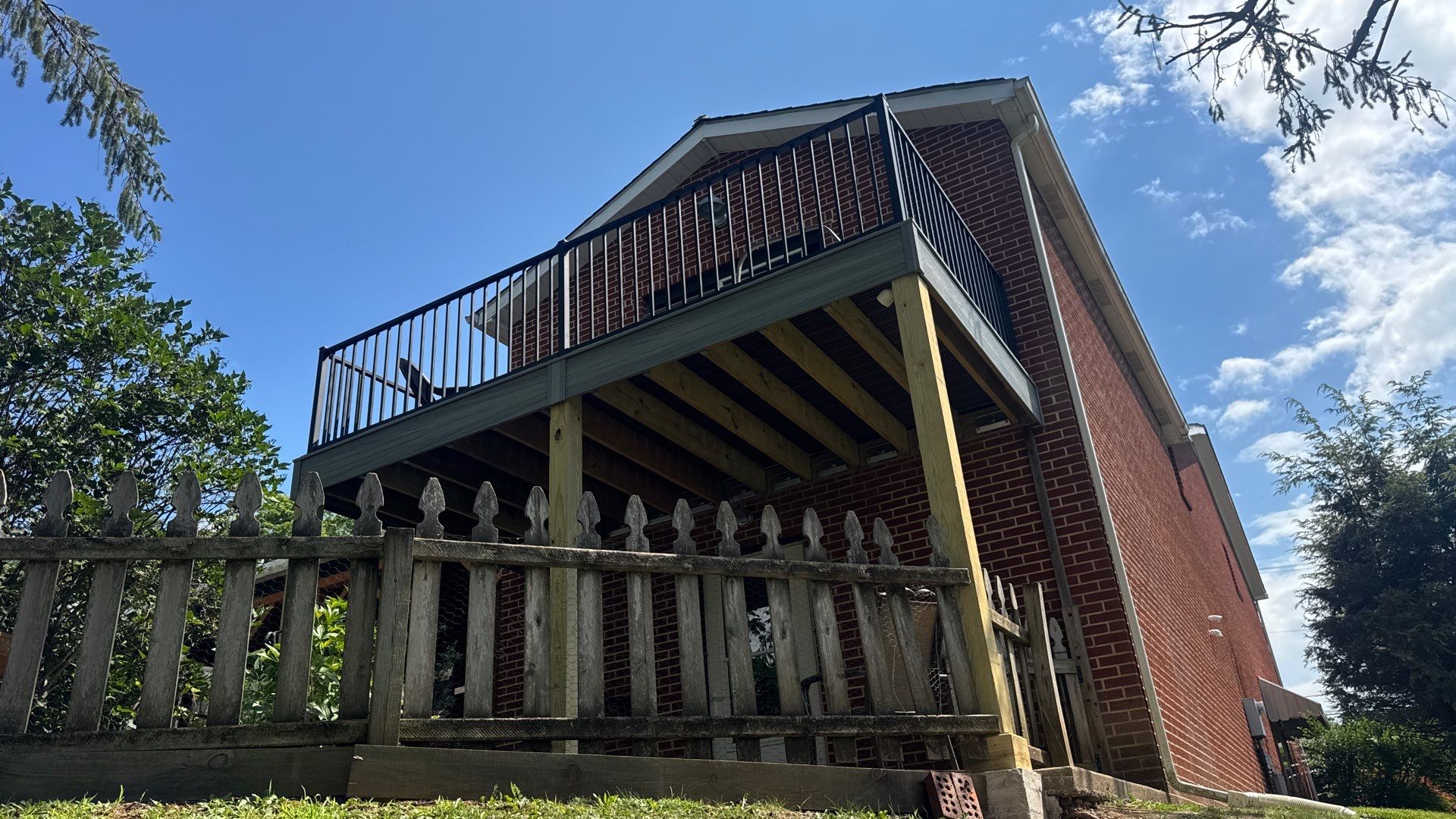 Elevated Composite Deck Rebuild with Black Metal Railing in Lewisburg by Walnut Hollow Decks & Outdoor Living