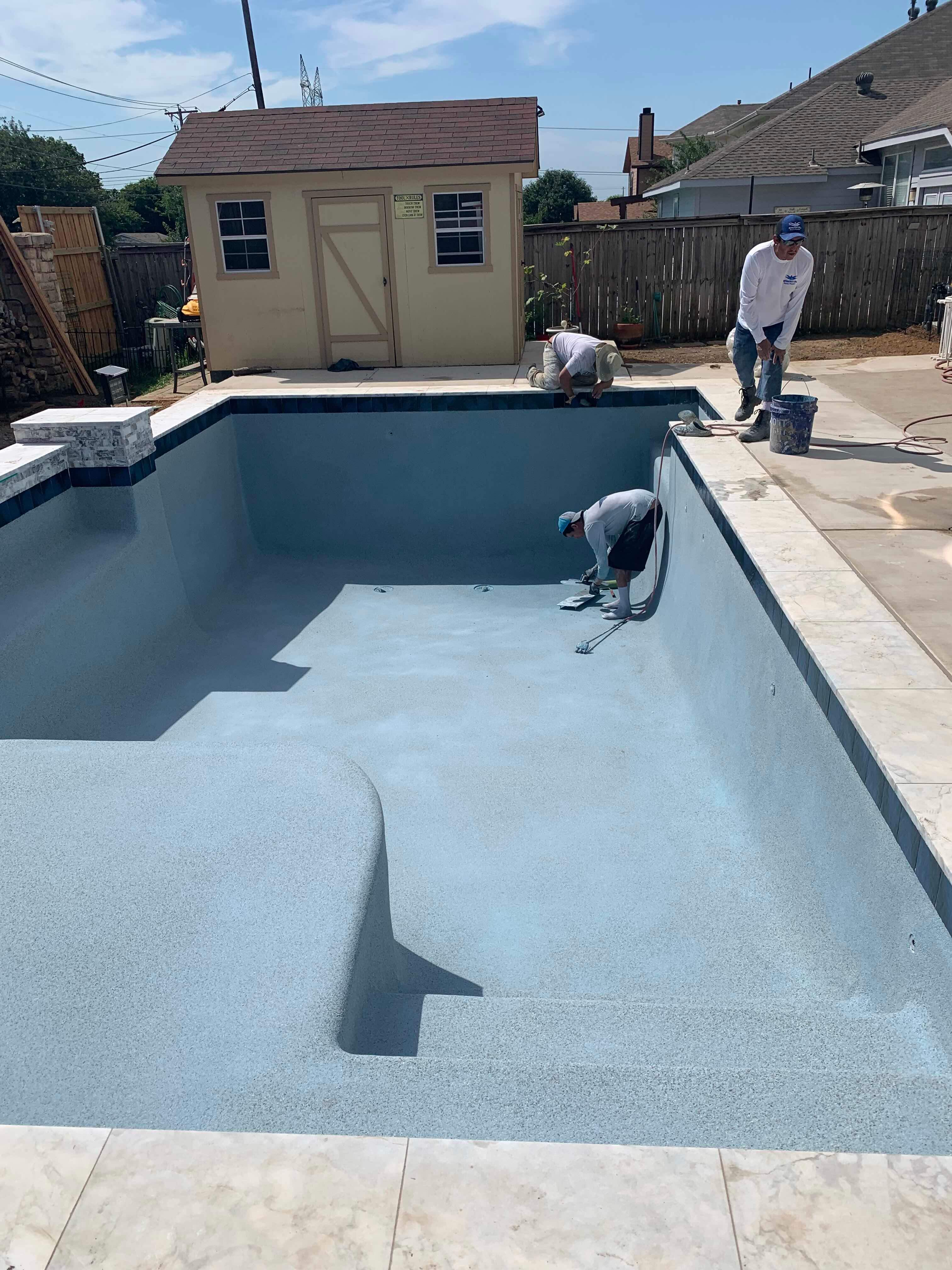 Geometric Pool with Raised Stone Accent Wall by Pinnacle Pools and Spas - DFW