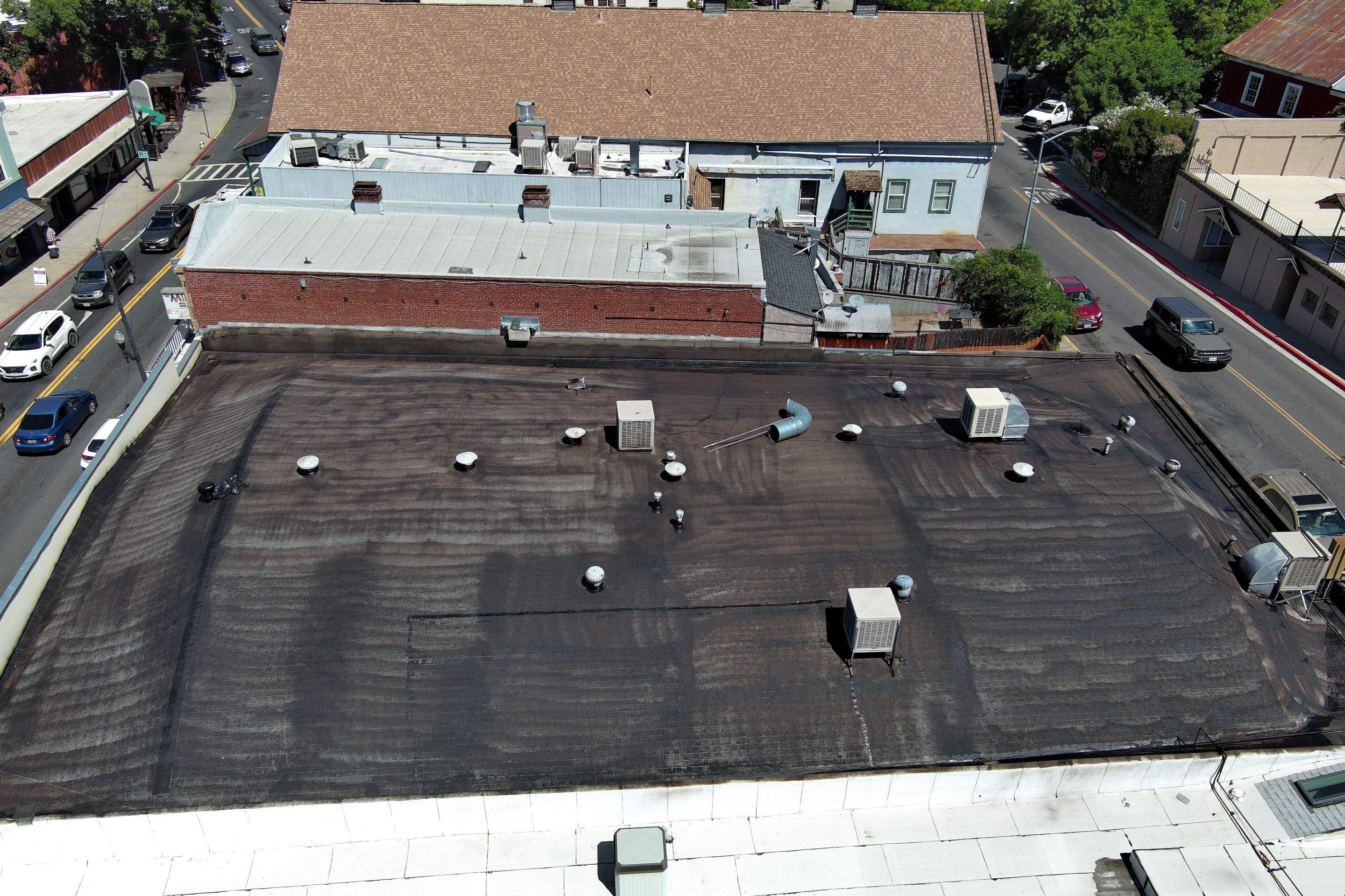 Foam and coatings on commercial roof by Straight Edge Roofing Inc