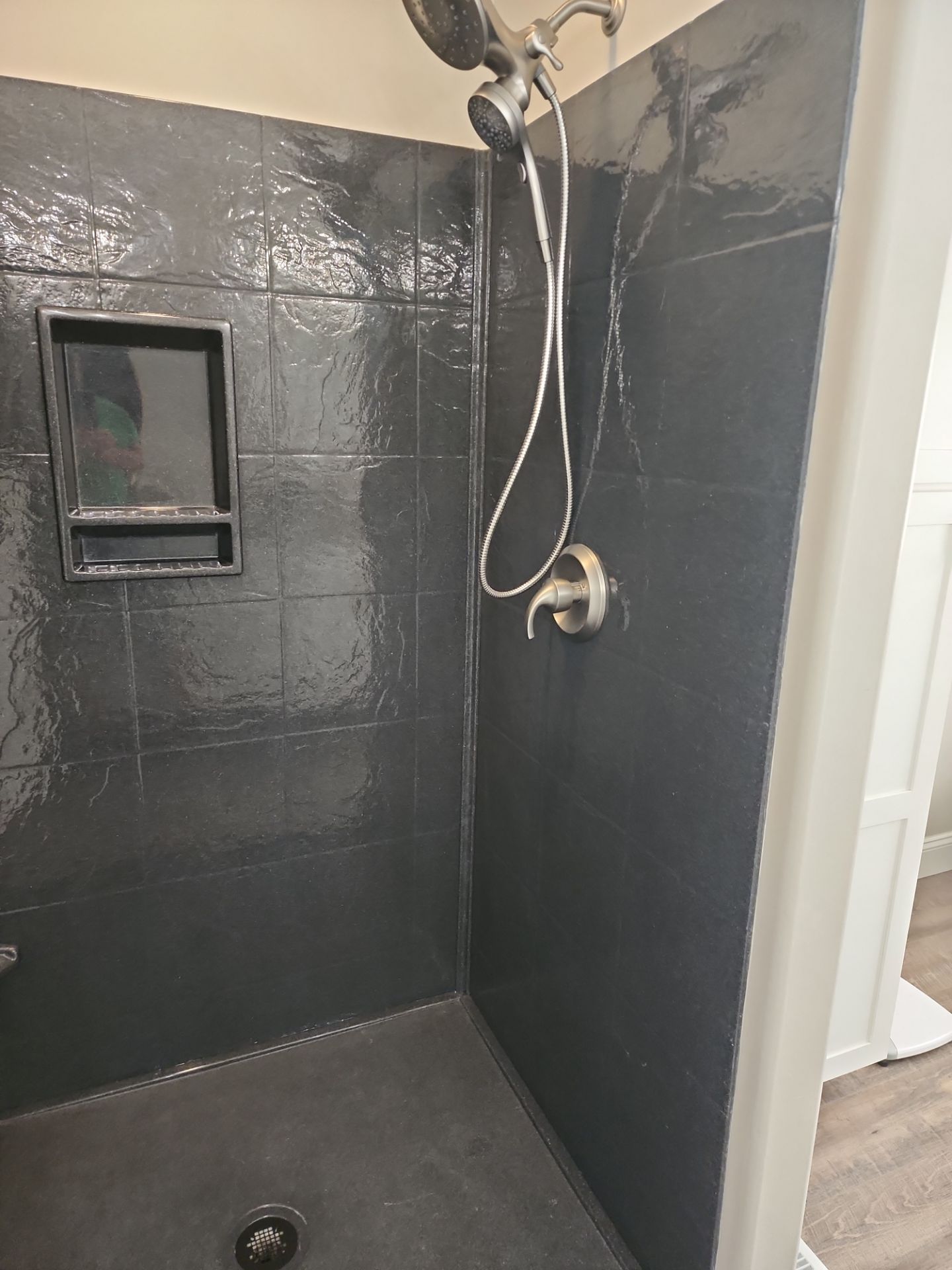 Master Bathroom Renovation Featuring Dark Textured Shower Panels in Branson West by Kitchen Works LLC