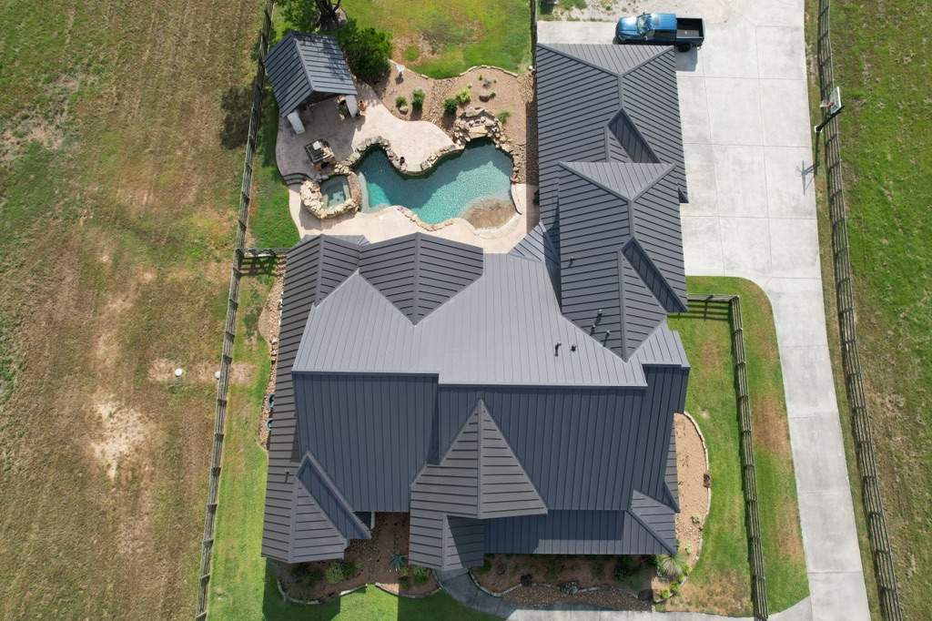 Residential Roofing Installation using Stamding Seam Metal by STX Roofing