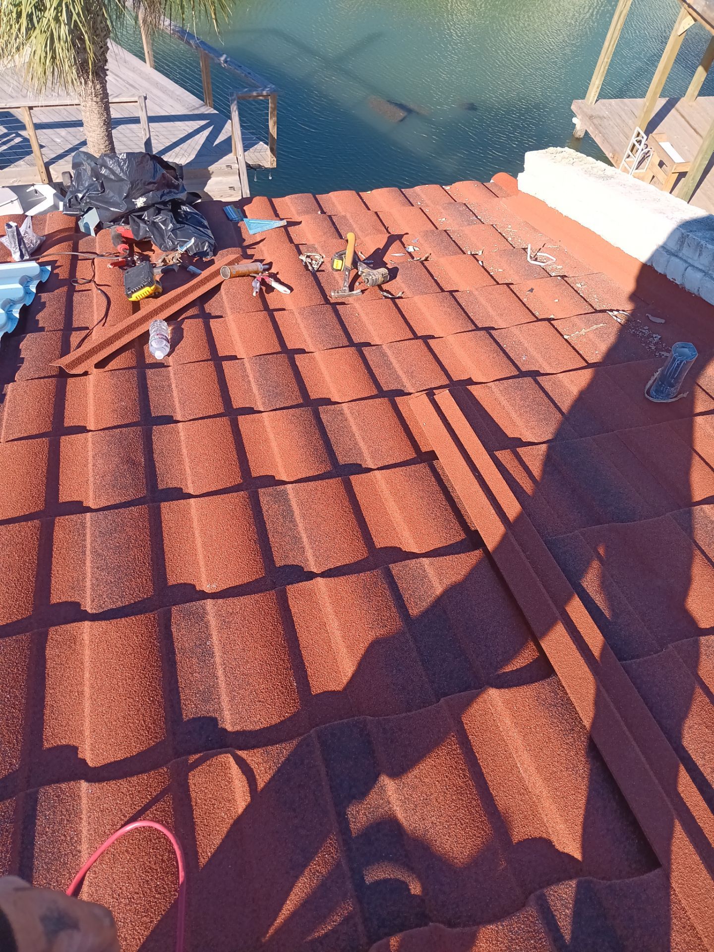 Off with the Tile and on with the TILCOR stone coated metal.  by Bayfront Roofing and Construction