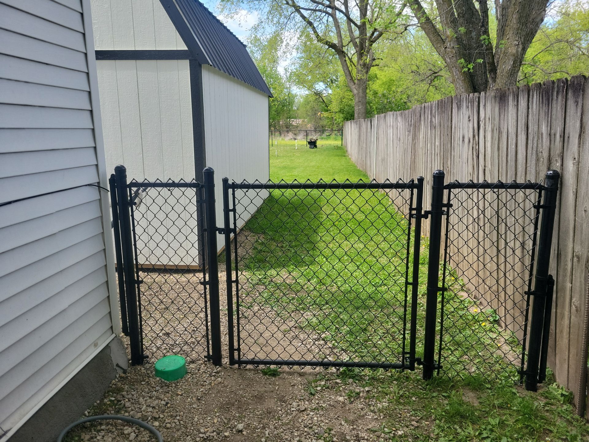 Black Chain Link Fence Installation and Gate in Traer by Perfect Picket Fence and Stain