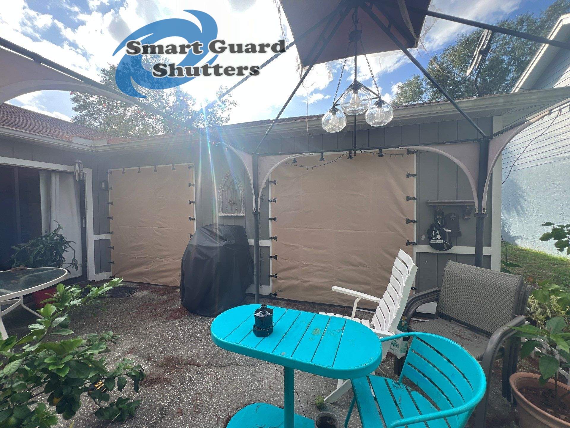 AstroGuard Hurricane Fabric in Tan & Impact Bahamas in Water Blue by Smart Guard Shutters