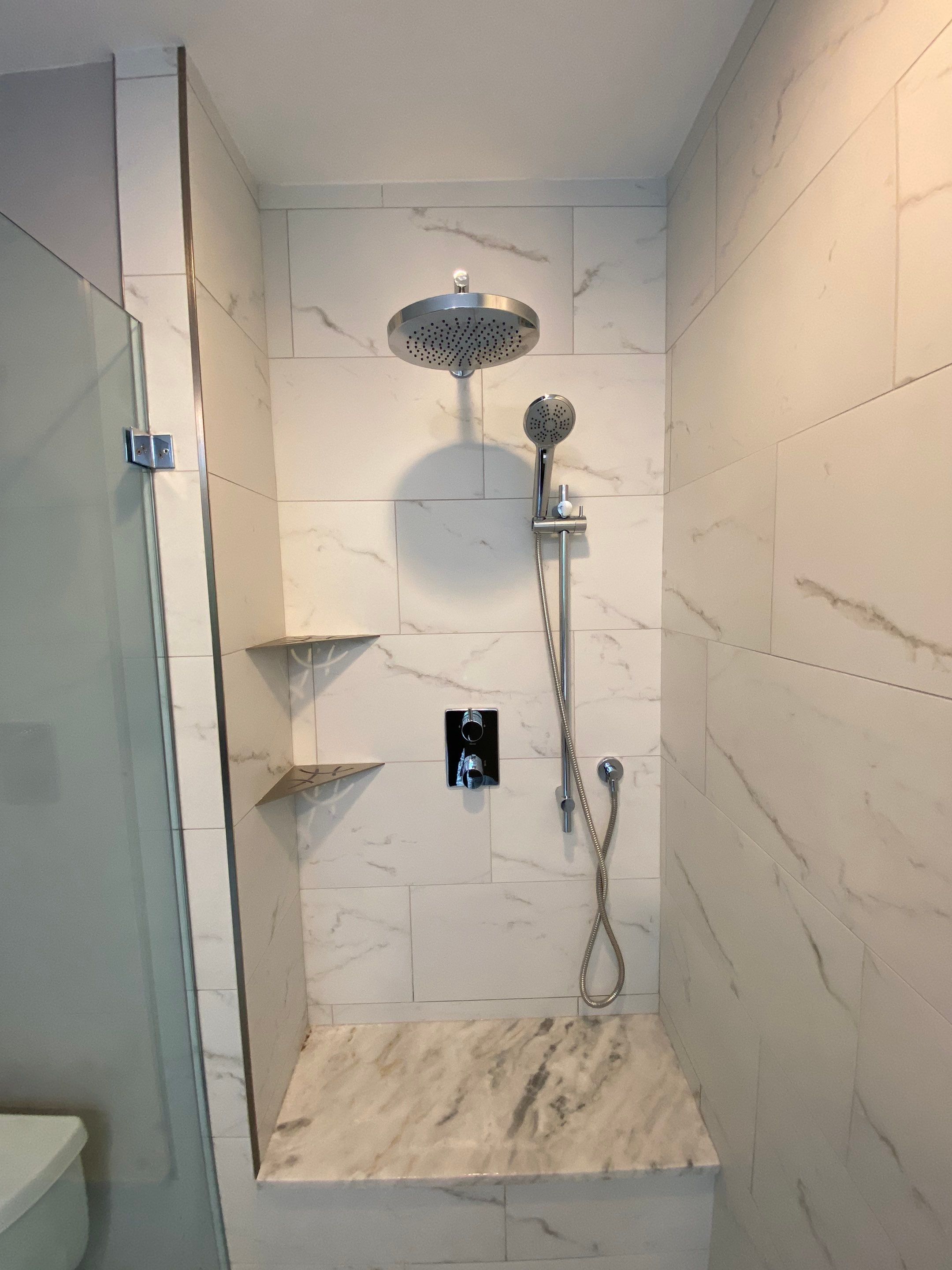 Luxury Bathroom Remodel with Marble Tiles in Kennesaw by Swift Home Renovations 