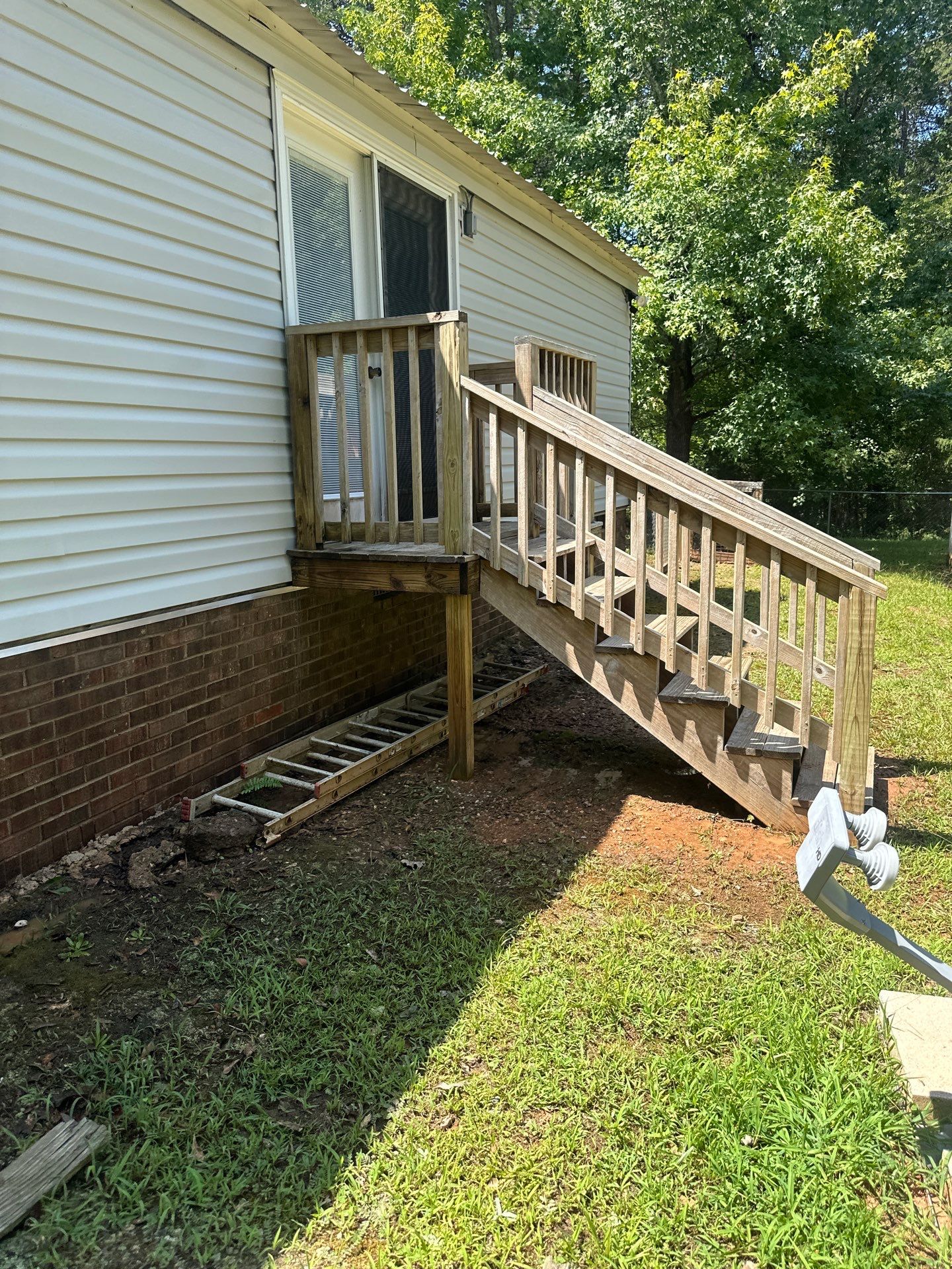 the service being done is cleaning the siding and steps of the house to remove dirt and grime from the surfaces