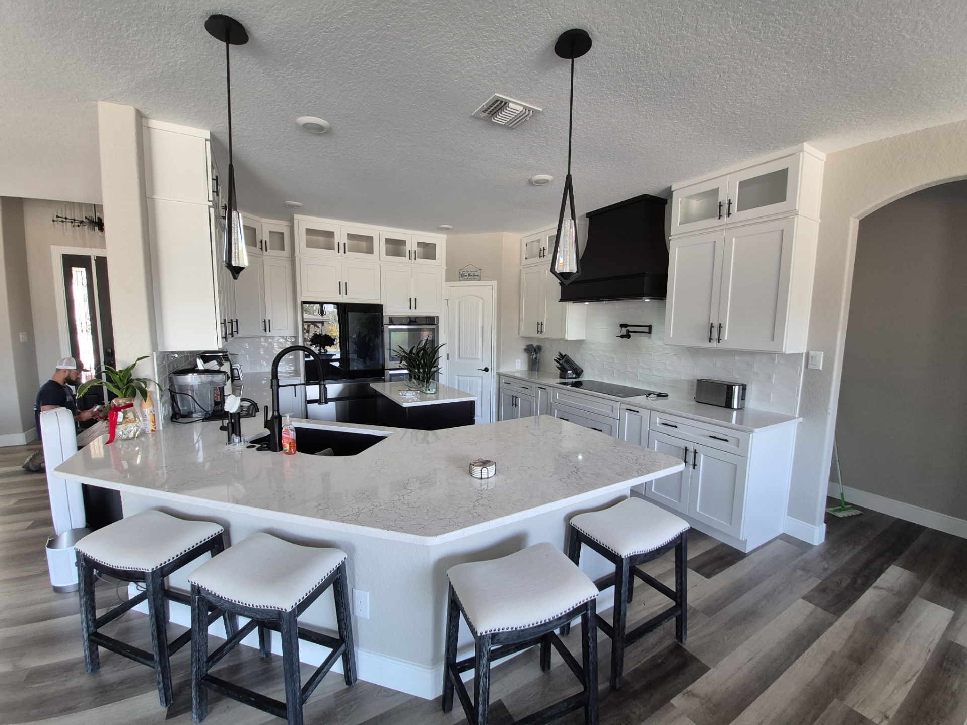 Modern White Kitchen Remodel in San Antonio Featuring Black Range Hood Before and After by Legacy Bath and Kitchen 