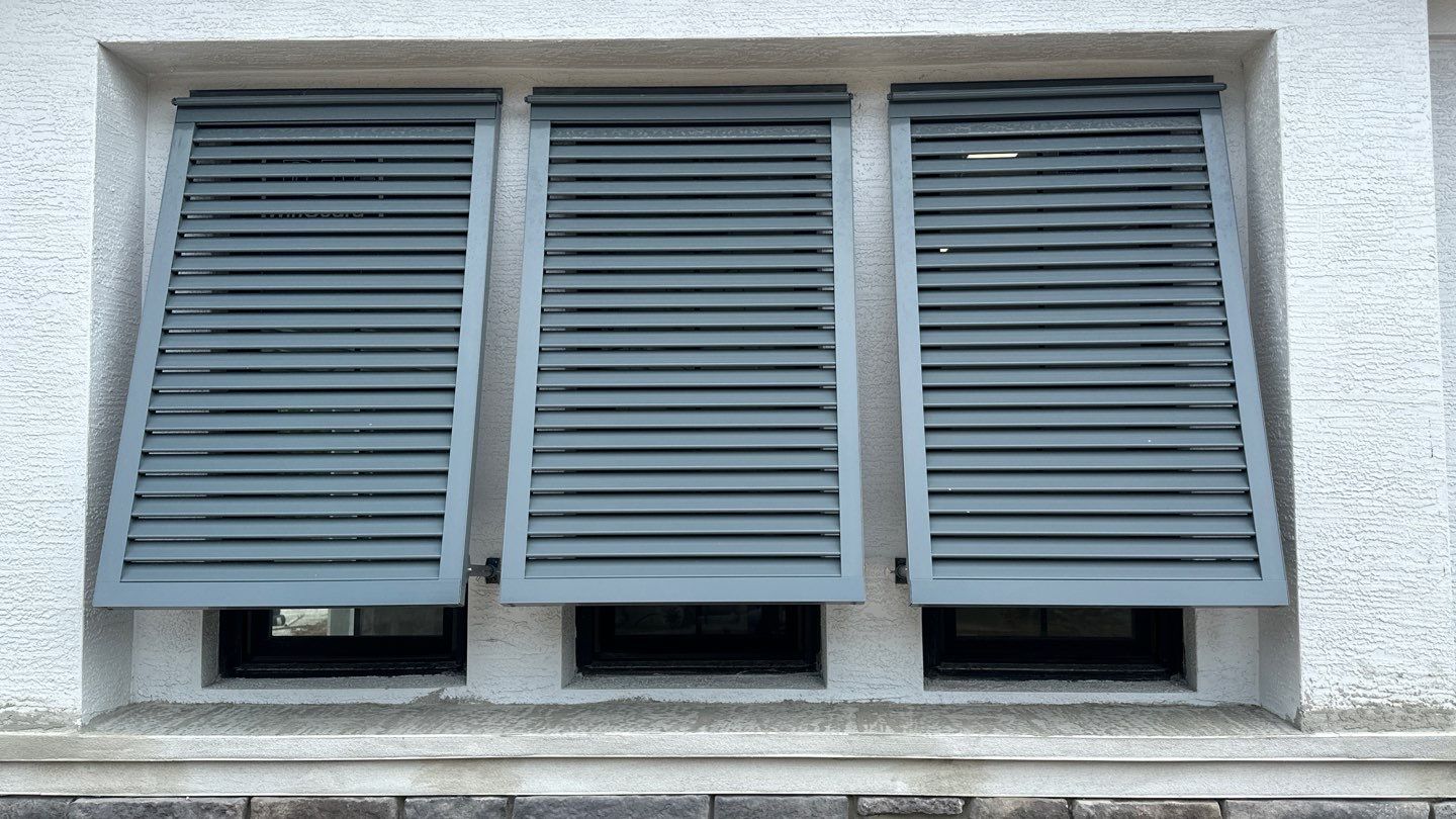 Bahama Shutters in Blue Grey by Smart Guard Shutters
