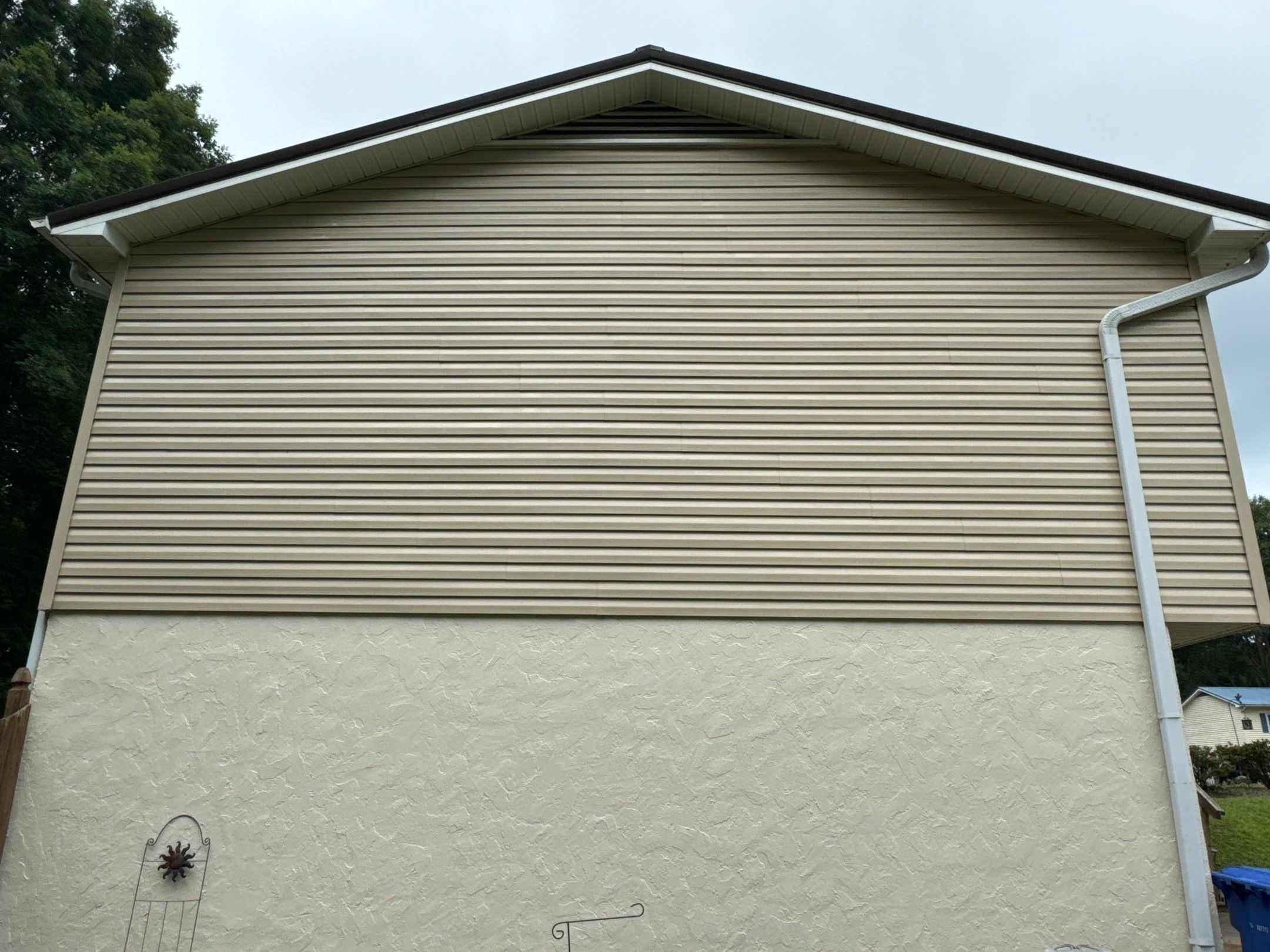 house washing of vinyl siding and stucco wall