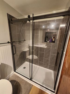 Modern Oatfield Bathroom Remodel Featuring Charcoal Shower and Dark Accents