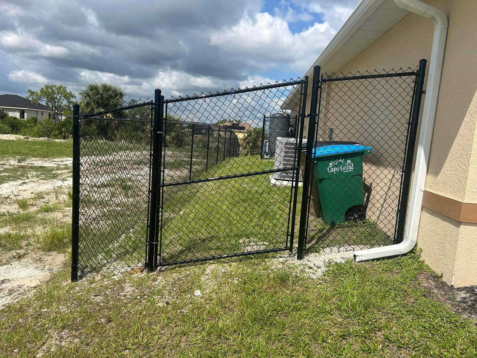 Black Chain Link Perimeter Fence and Utility Enclosure in Cape Coral by True Fence LLC