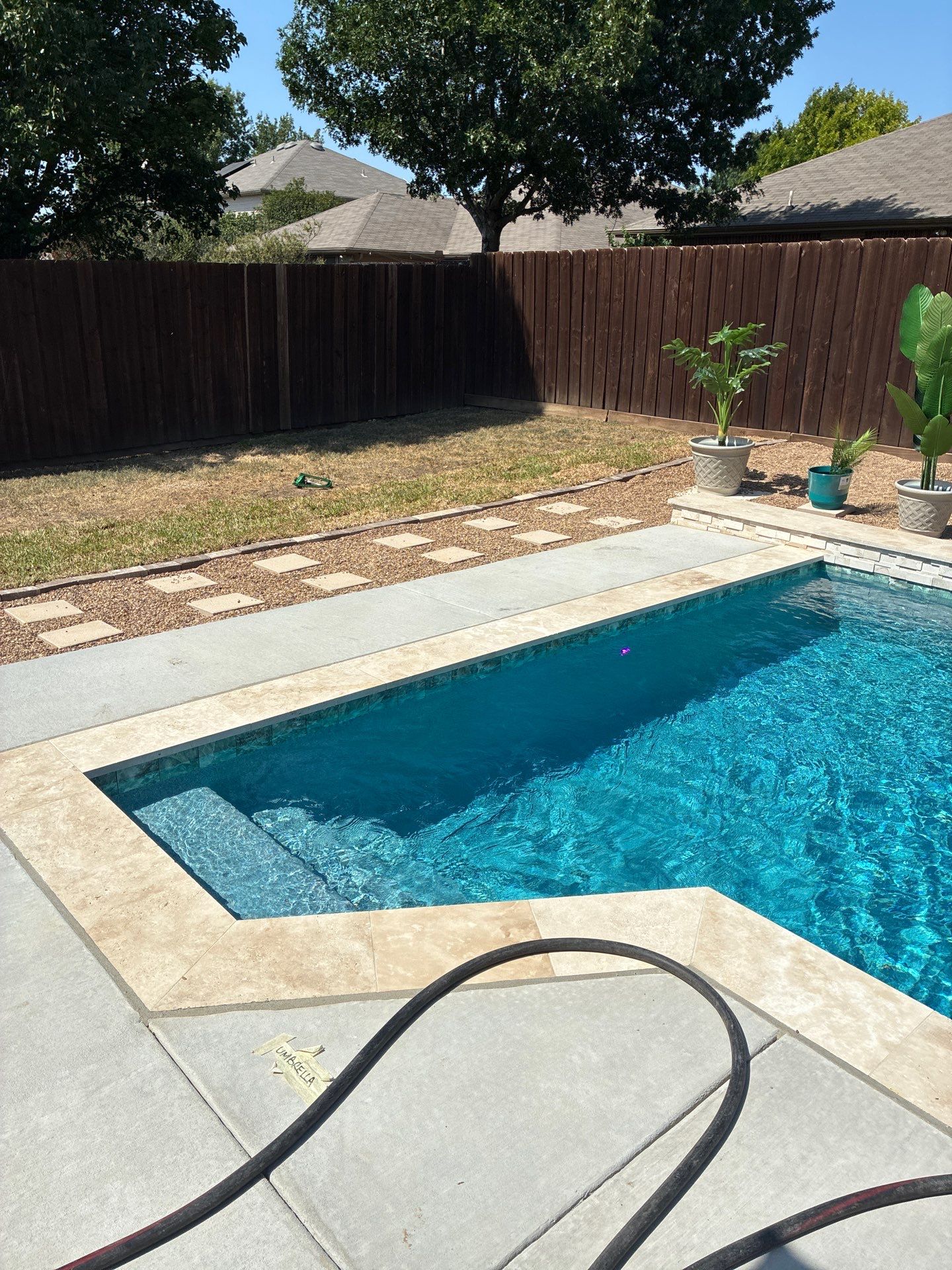 Modern Geometric Pool with Travertine Coping and Lush Landscaping by Pinnacle Pools and Spas - DFW