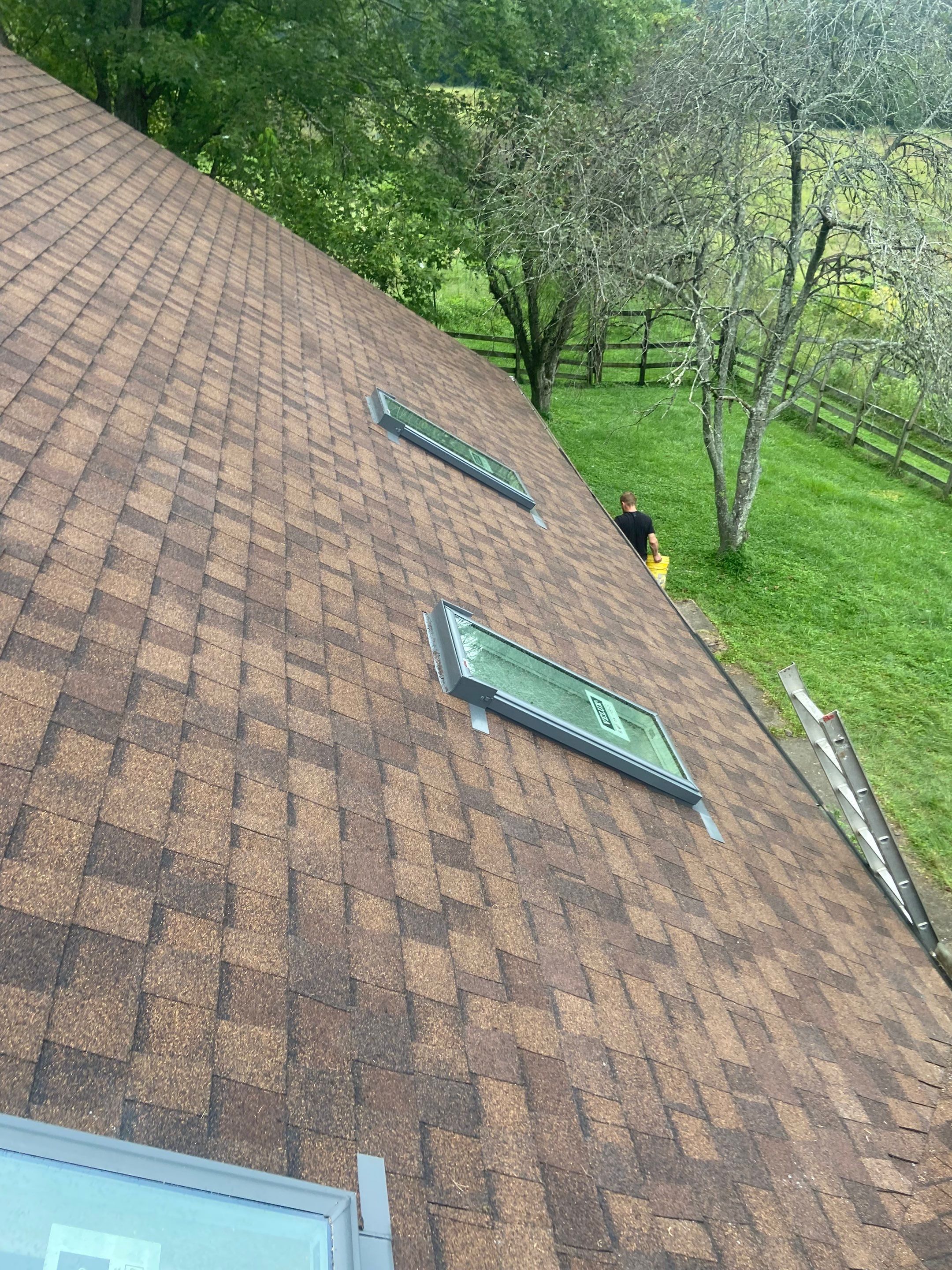 Shingle Roofing with Velux Skylight replacement and stone chimney flashing  by Secure Construction Company Inc