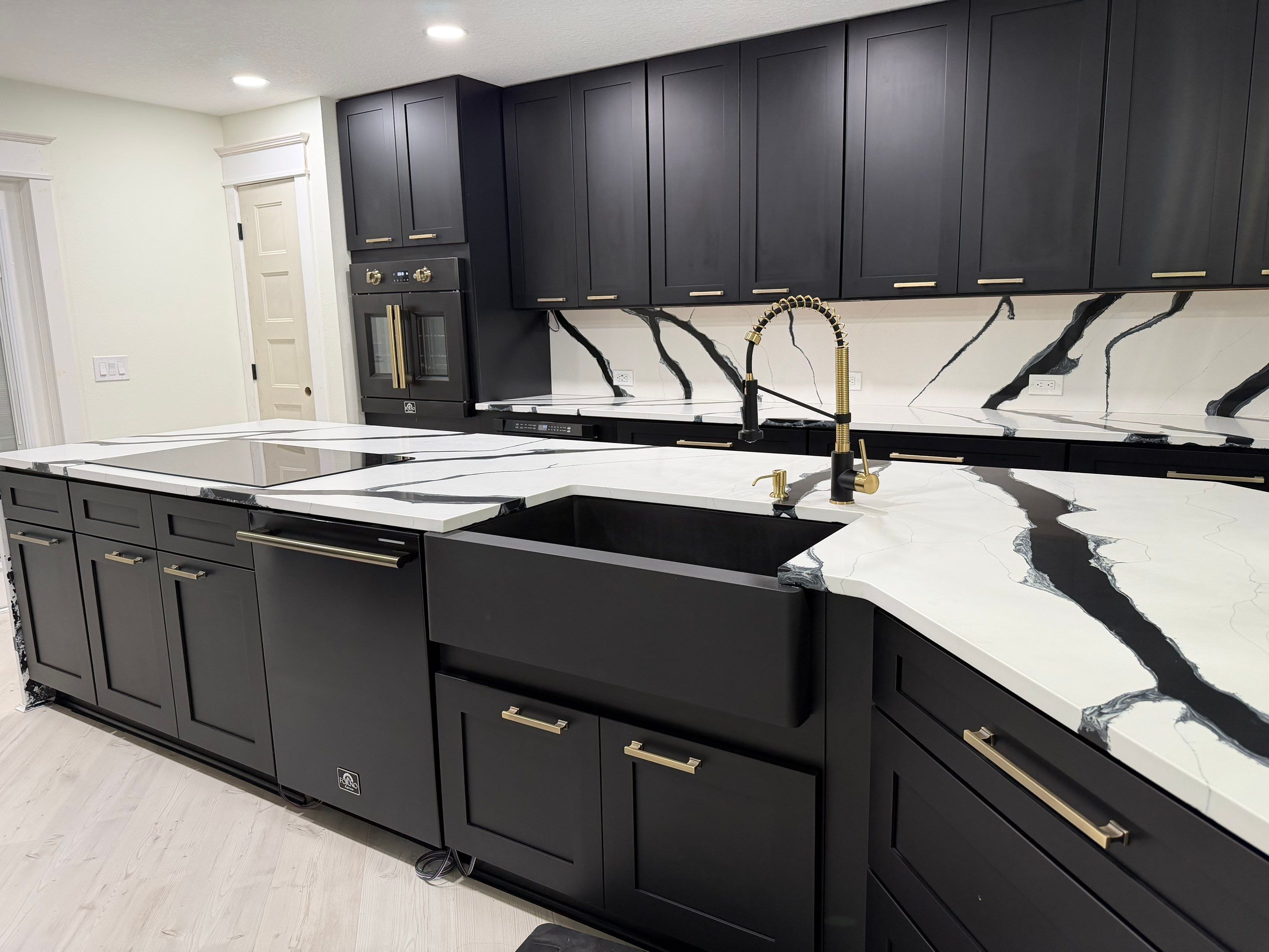 Modern Kitchen Remodel in Port Orange Featuring Waterfall Quartz Island by Acies Renovations